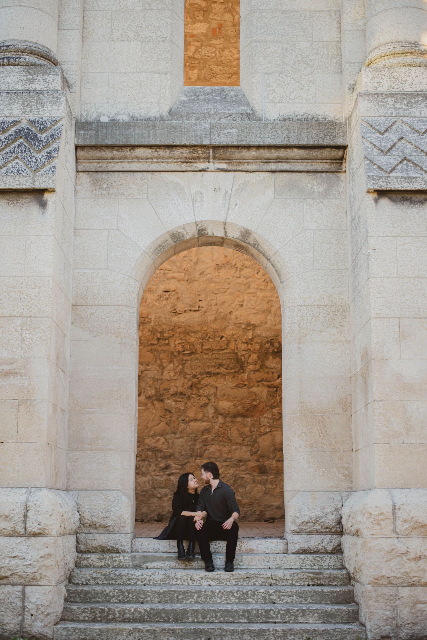 Couple kiss on steps of cathedral