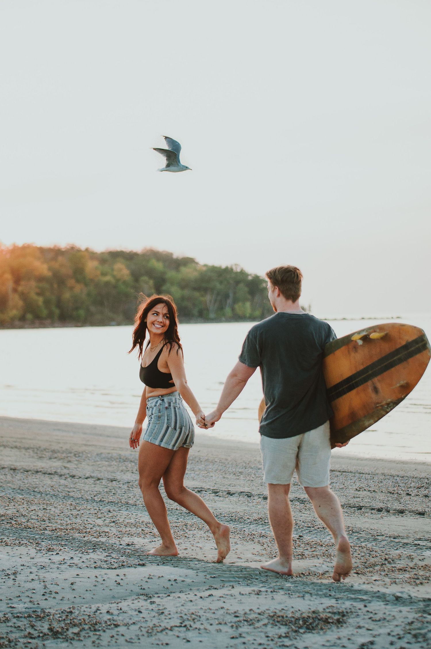 Couple walks down beach