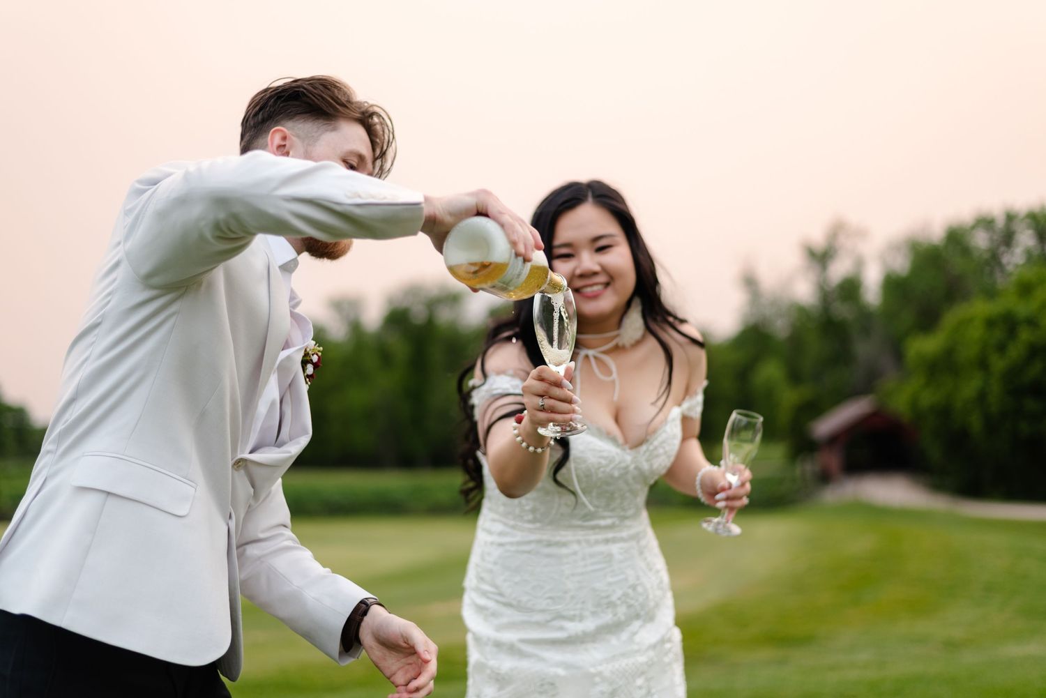 bride and groom pour champagne on gold course