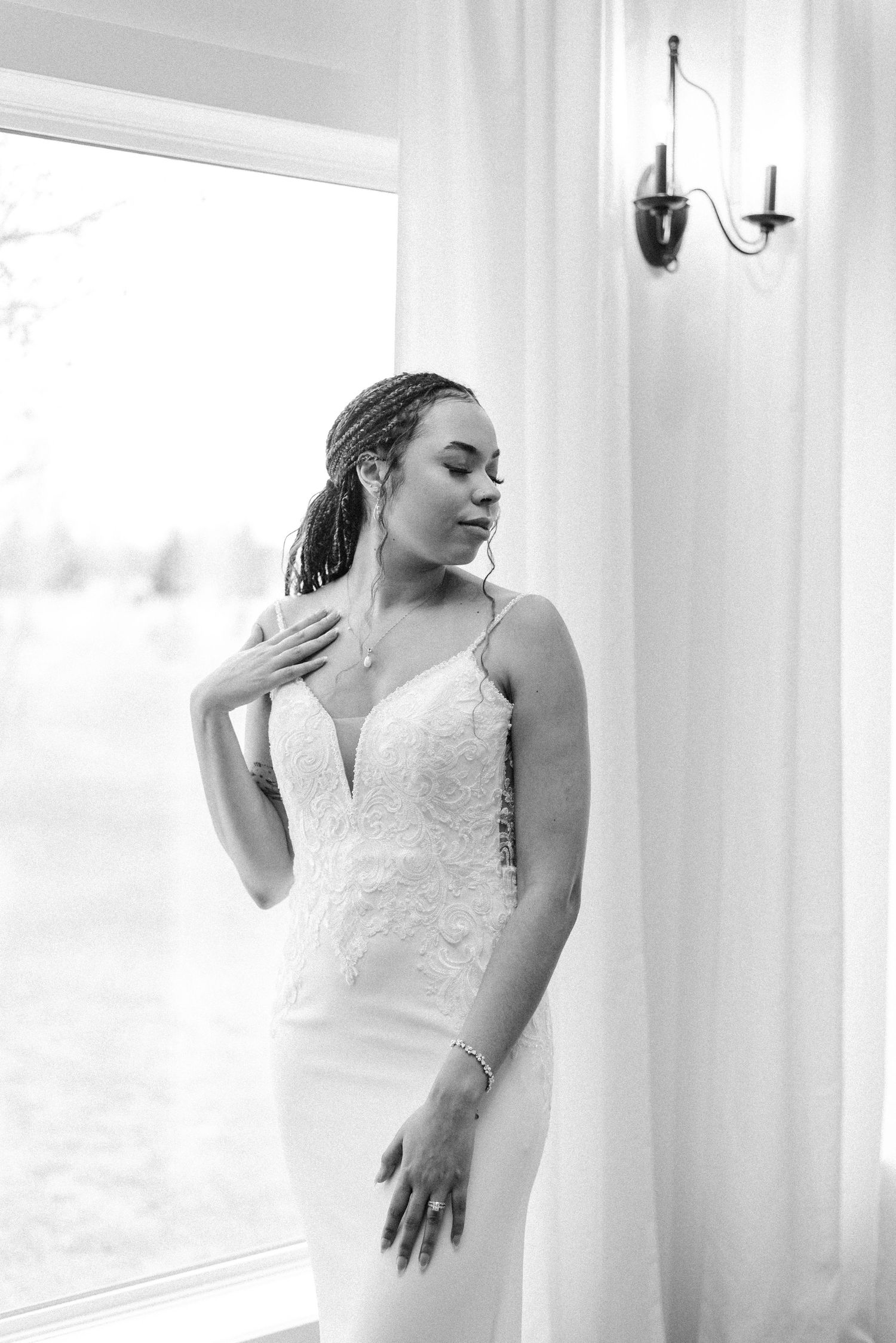 A bride posing in-front of a window