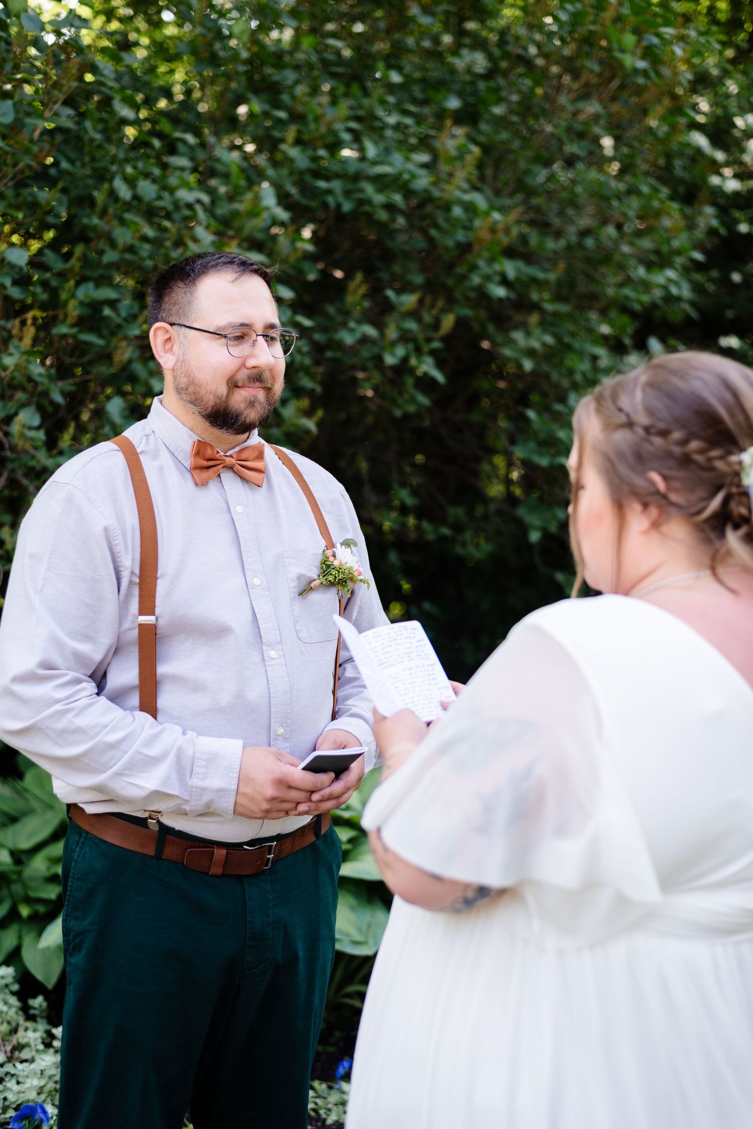 a couple reads their wedding vows privately