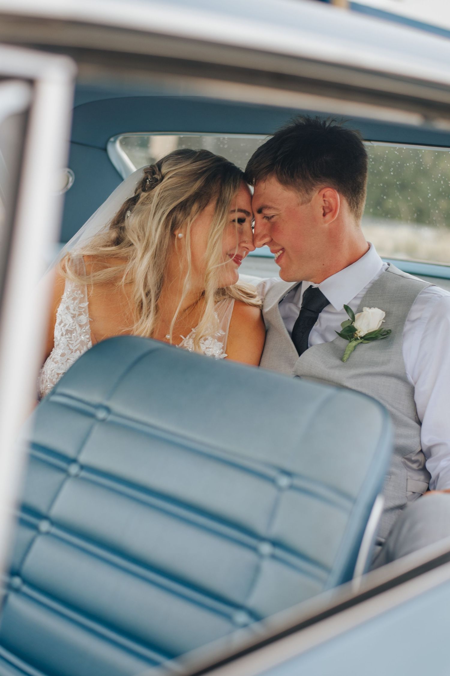 Couple look at eachother in backside of car