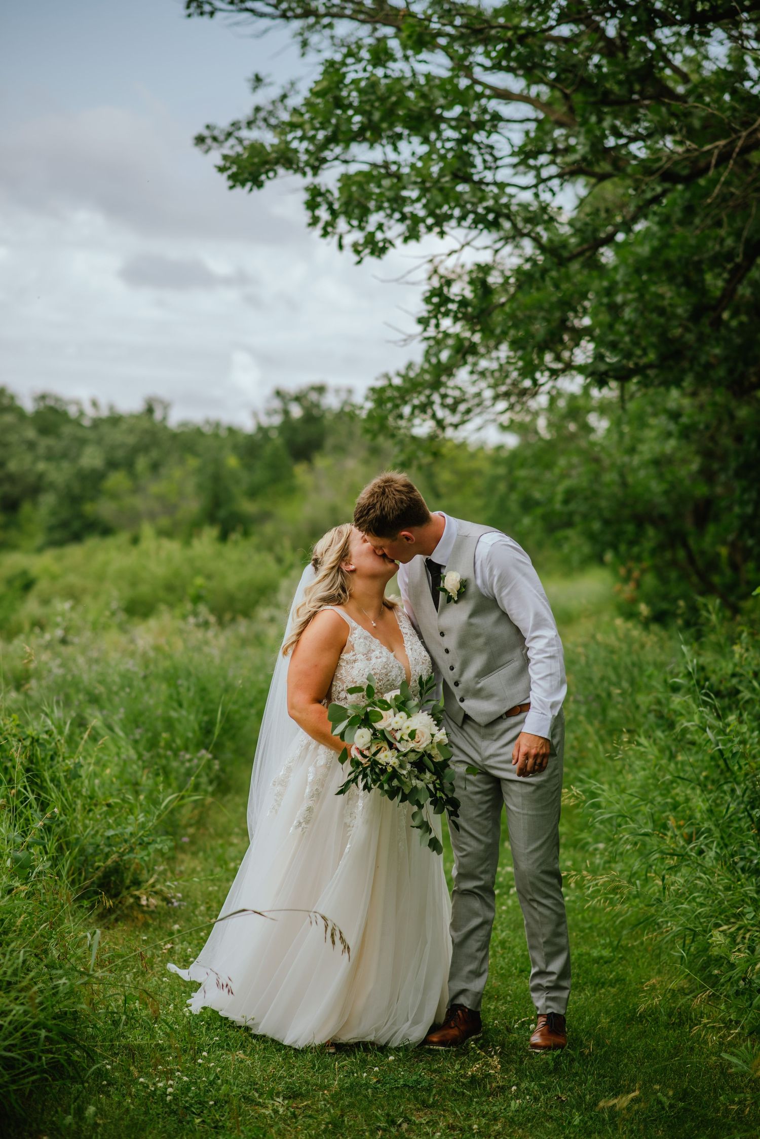 couple kiss on grassy path