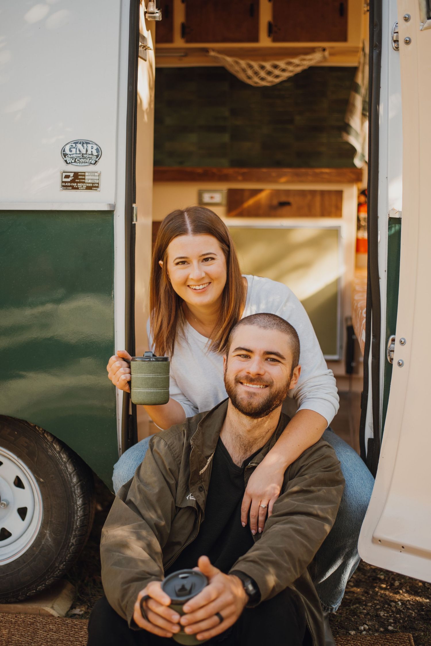 Couple look at  camera in against camper