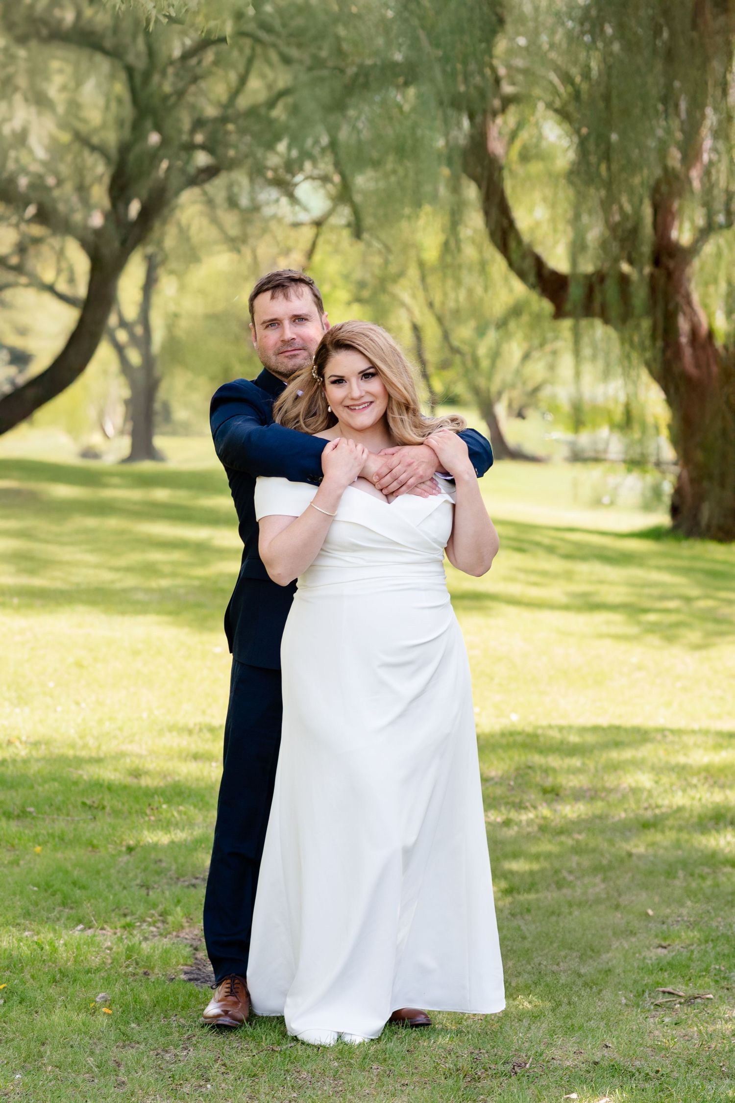 a couple embrace each other on their wedding day
