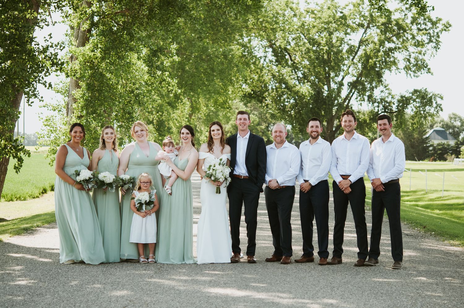 Wedding party poses for photo during photoshoot after wedding in Manitoba.
