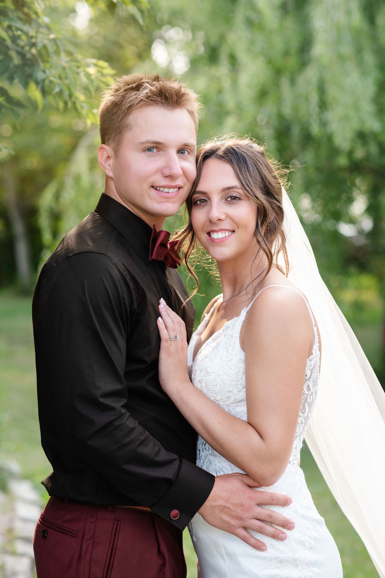 A couple pose together on their wedding day