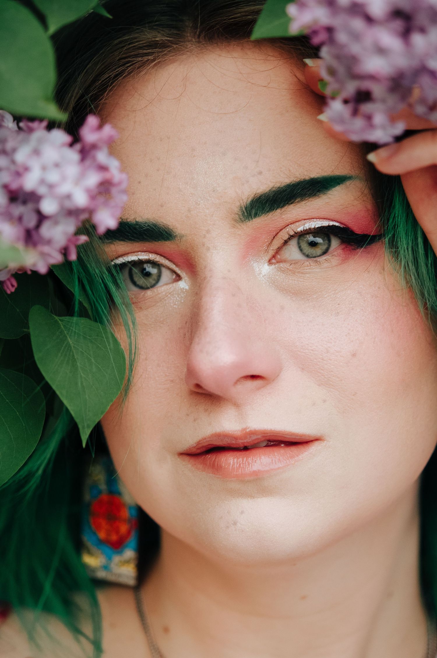 Woman poses in lilacs in winnipeg during photoshoot