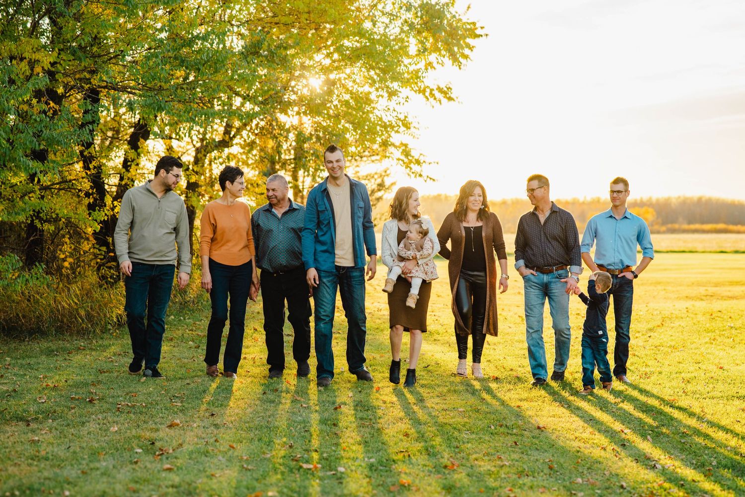 Family walks against sunset