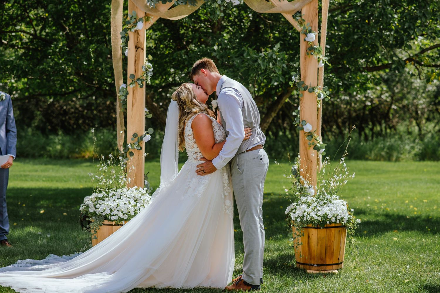 Bride and groom first kiss under alter