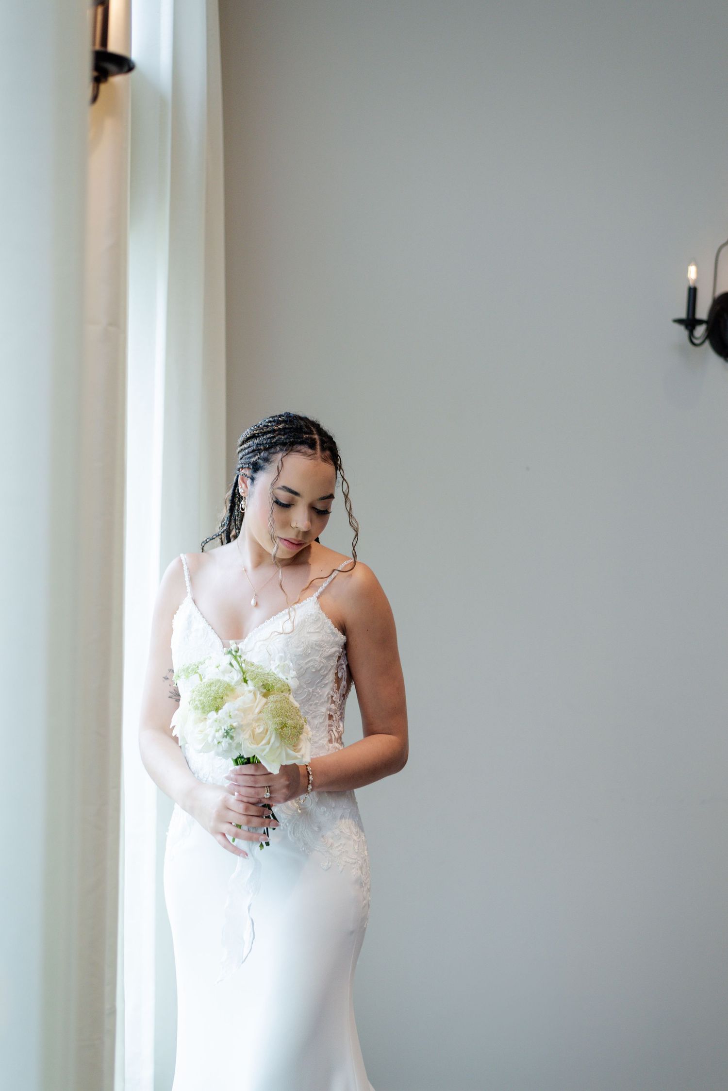 A bride posing in-front of a window