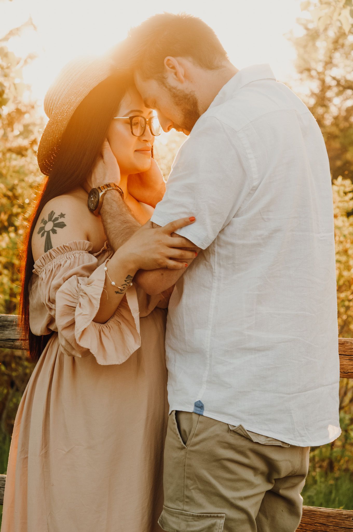 man holds womans face in sunset