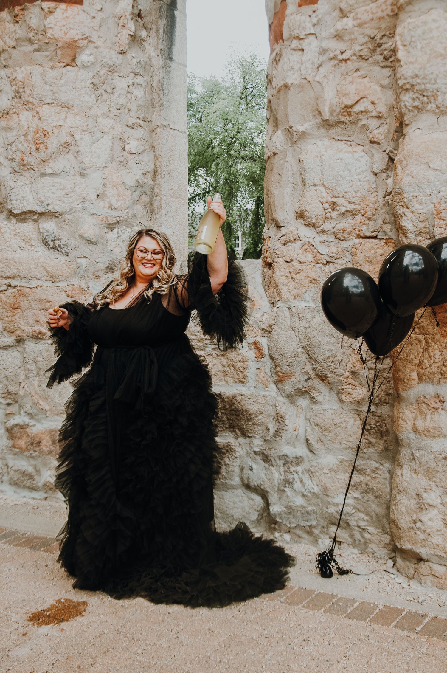 Woman pops champagne for her birthday celebration during photoshoot