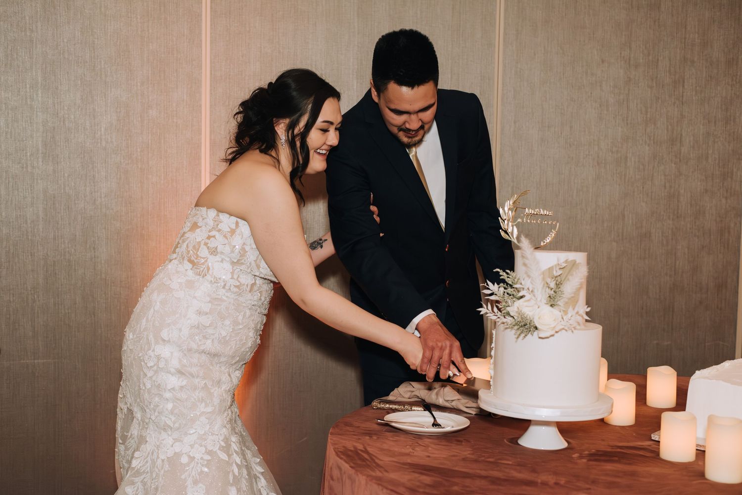bride and groom cut wedding cake