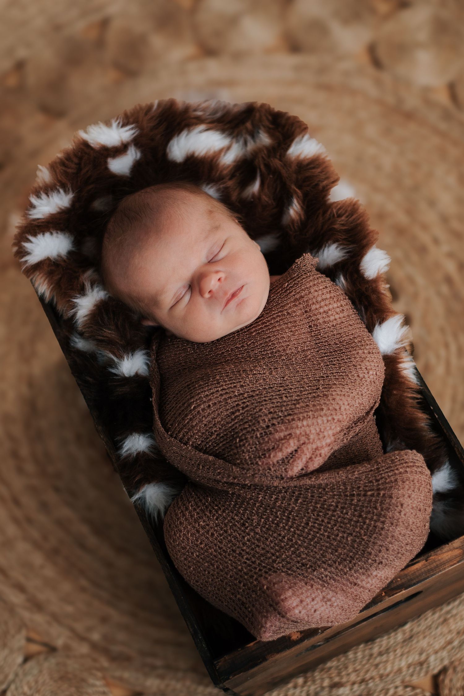 Baby lays wrapped in box