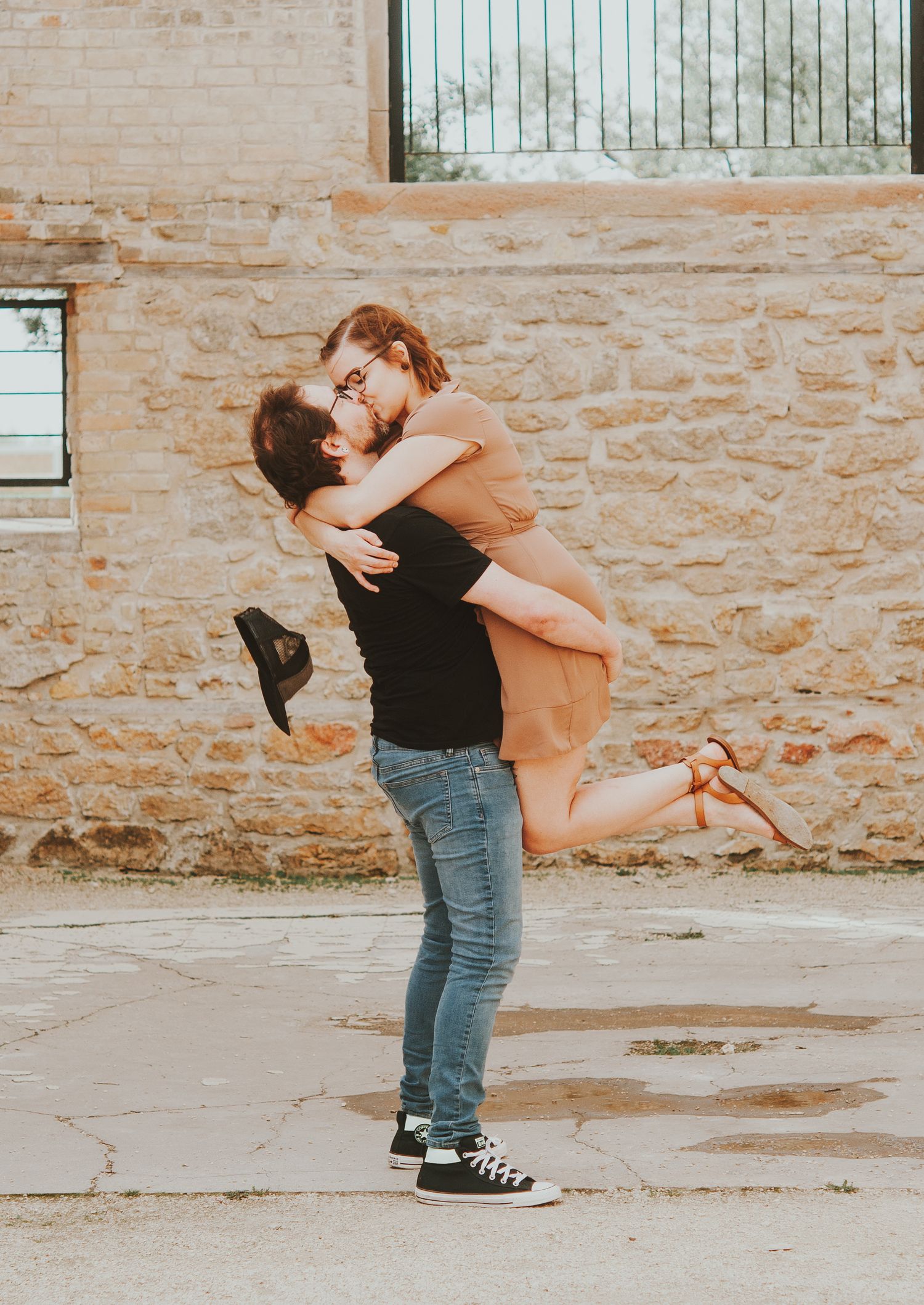 Couple embrace a kiss during photoshoot