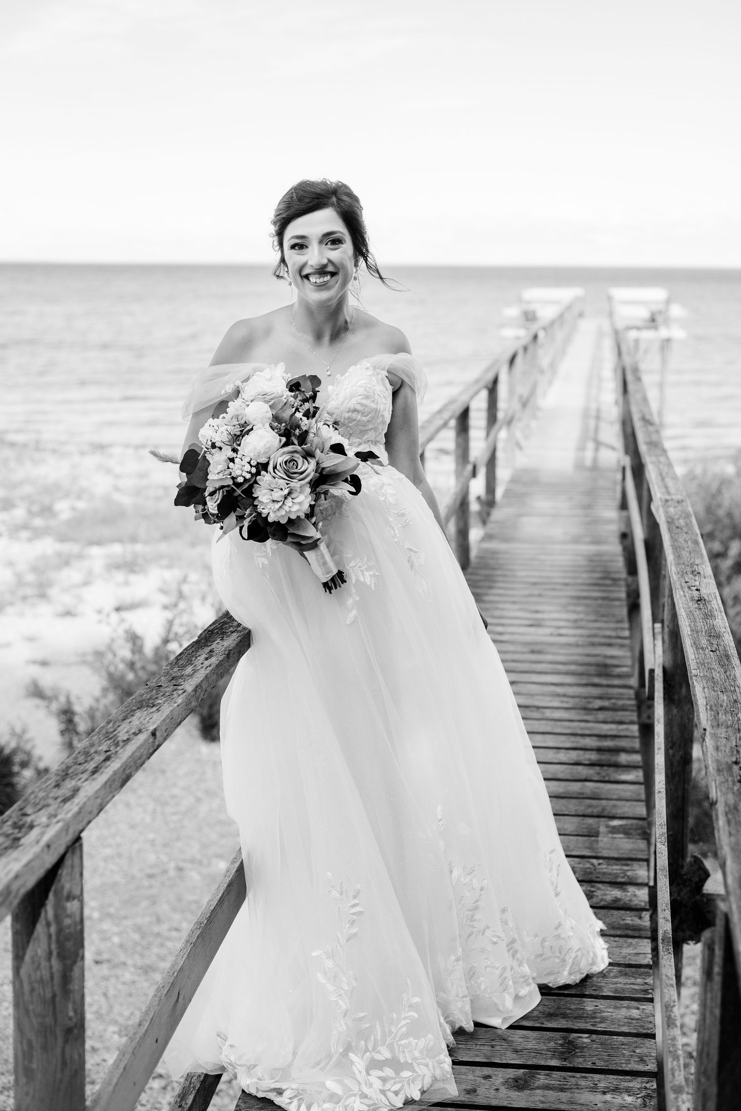 bride sits on pier