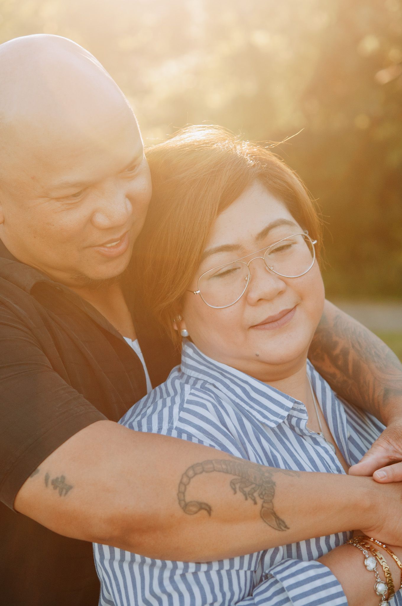man holds woman from behind
