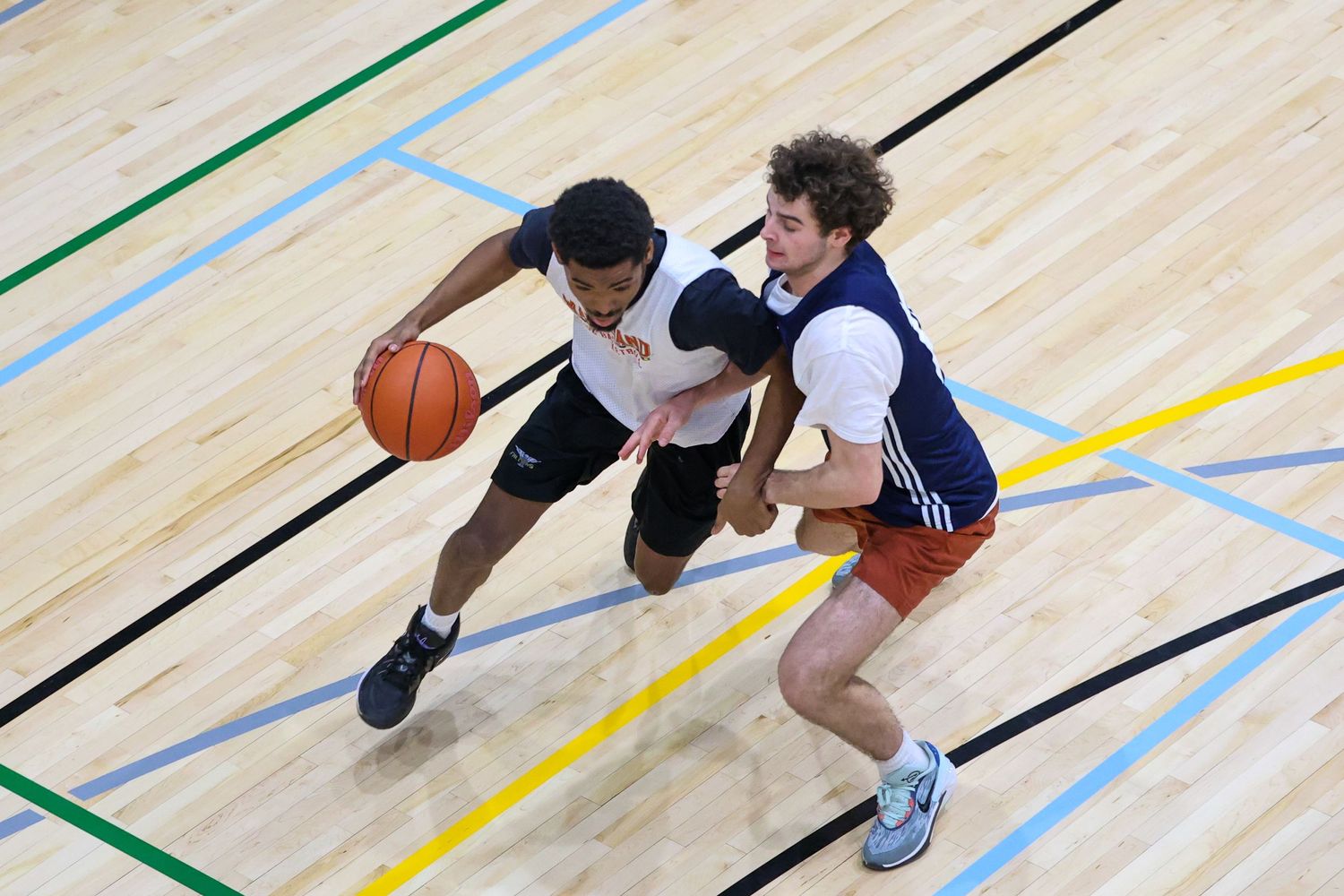 Maryland Club Basketball player dribbling the ball.