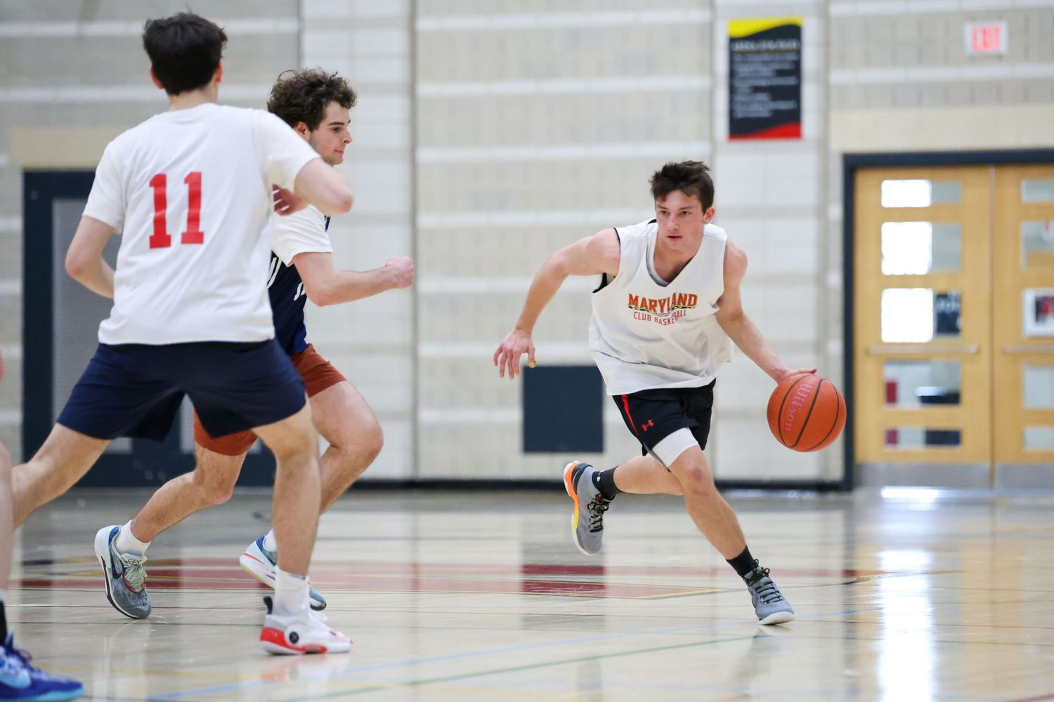 UMD Club Basketball player dribbling the ball.