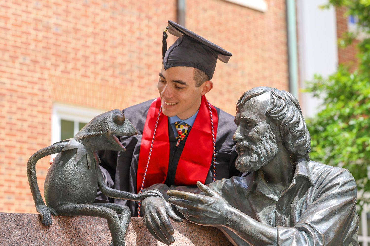 UMD grad with the Jim Henson Statue