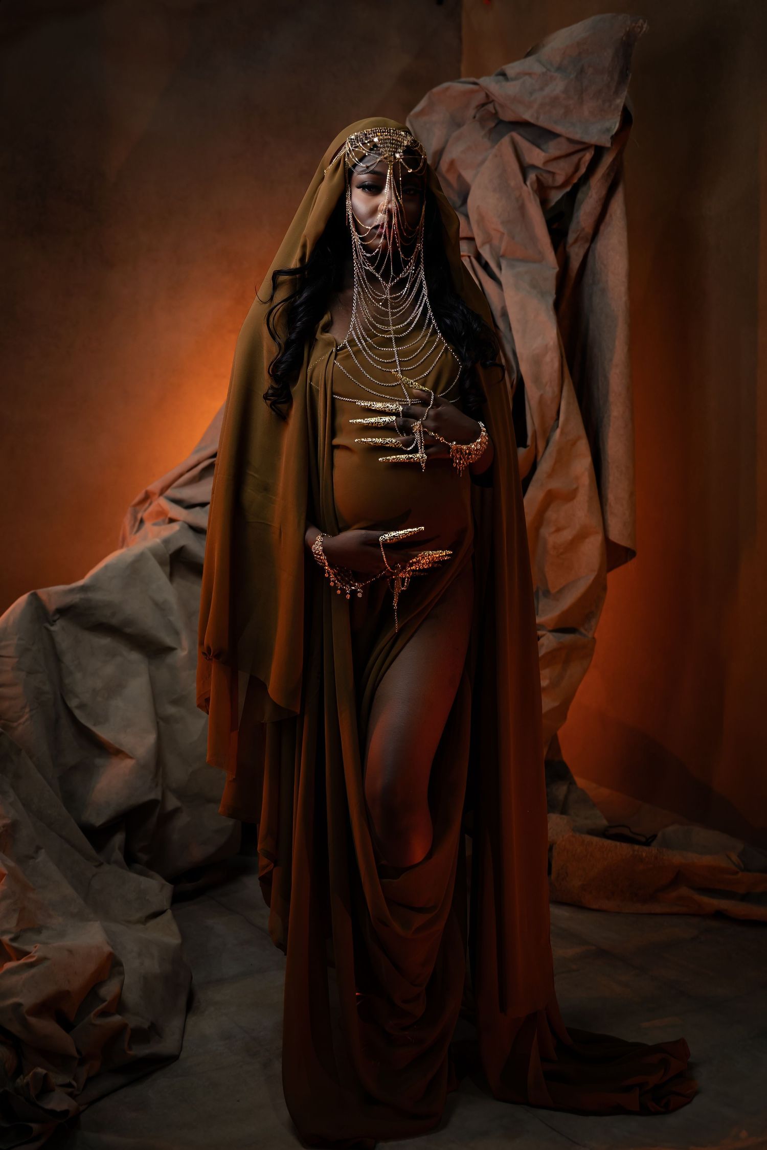 Artistic portrait series in rich brown tones with dramatic fabric and jewelry styling.