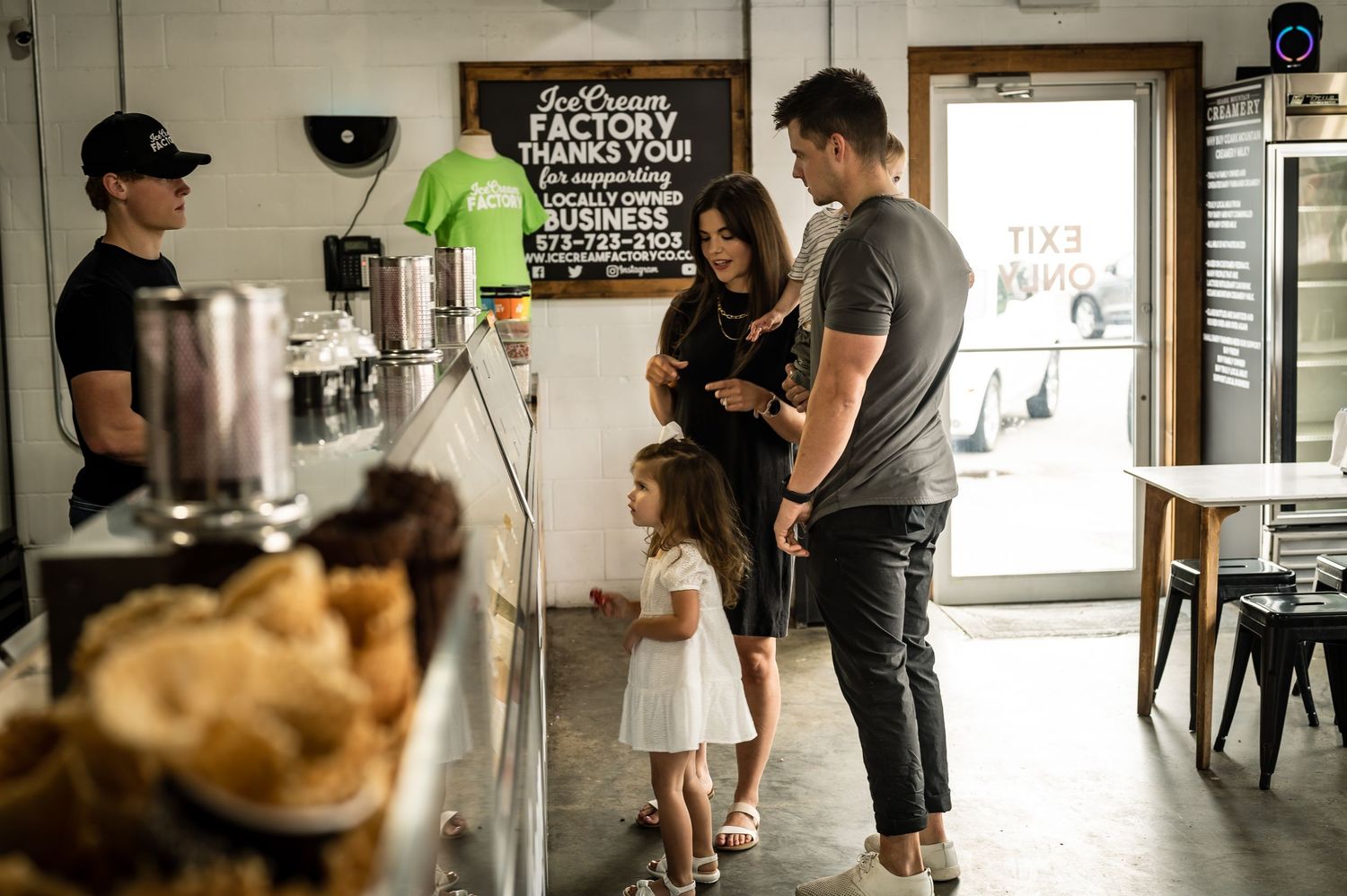 People gathered inside a modern retail space with industrial style decor and lighting.