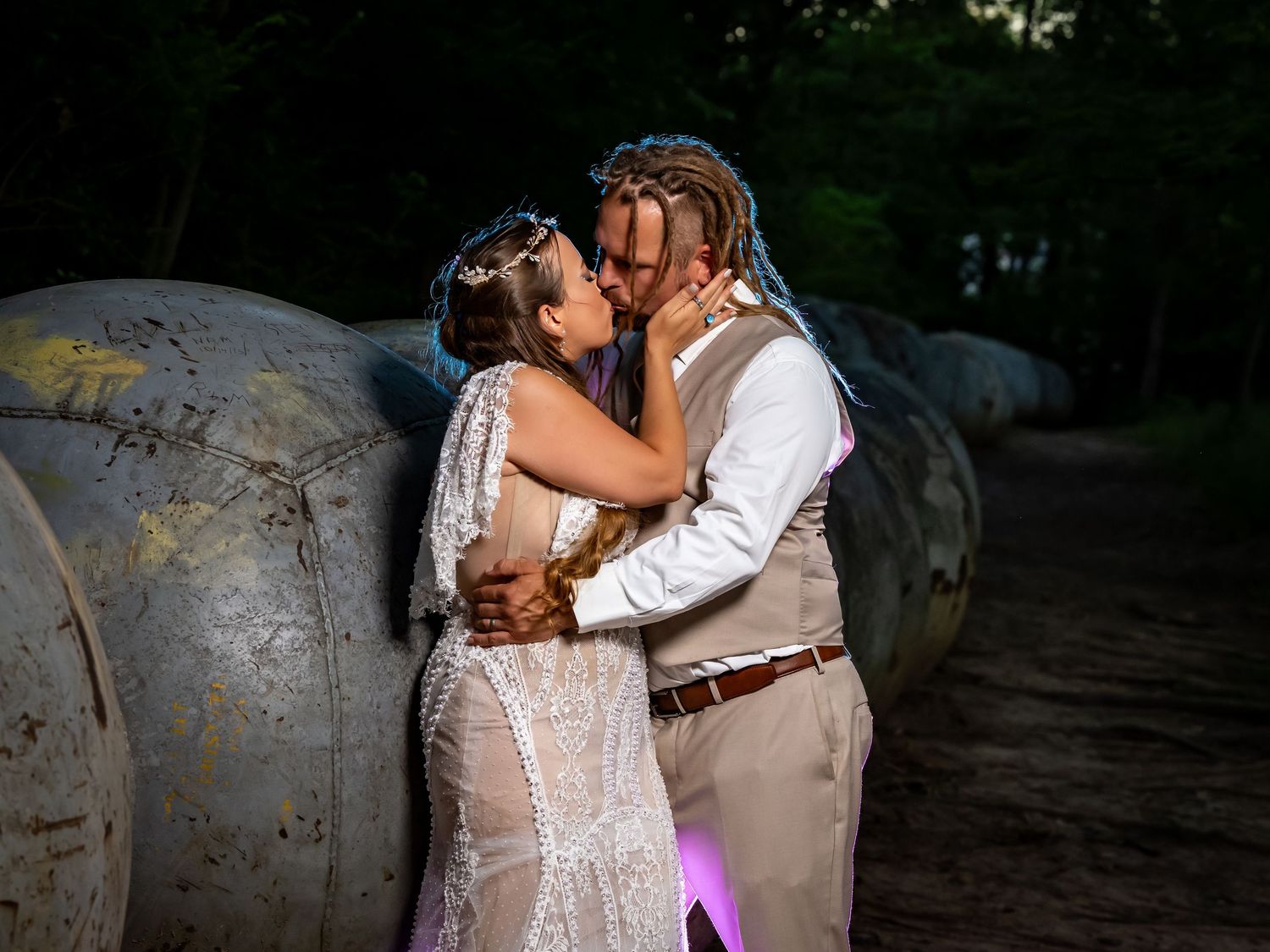 Intimate wedding portraits captured at dusk with purple accent lighting.