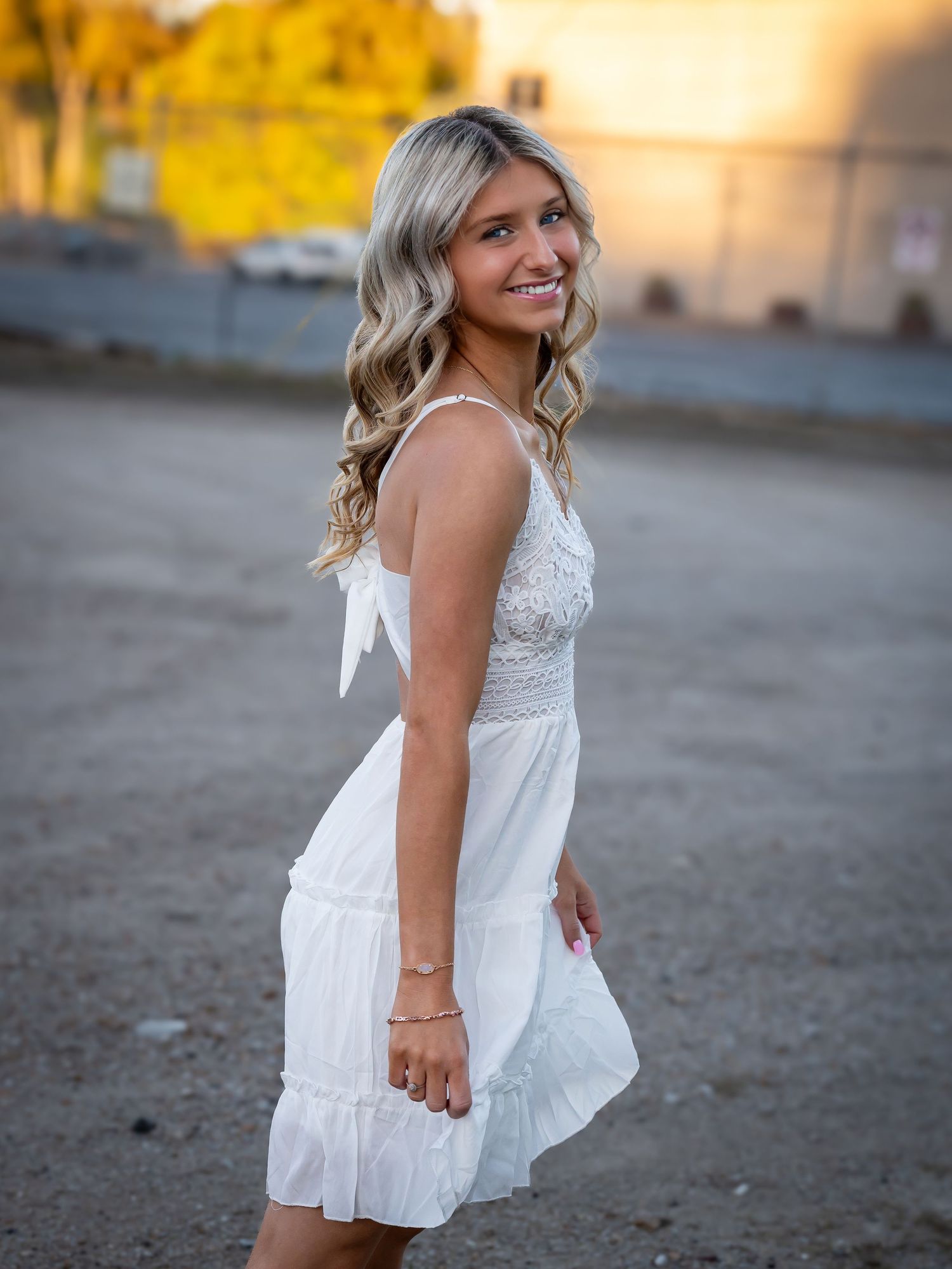 Portrait series in flowing white summer dress during golden hour outdoors.