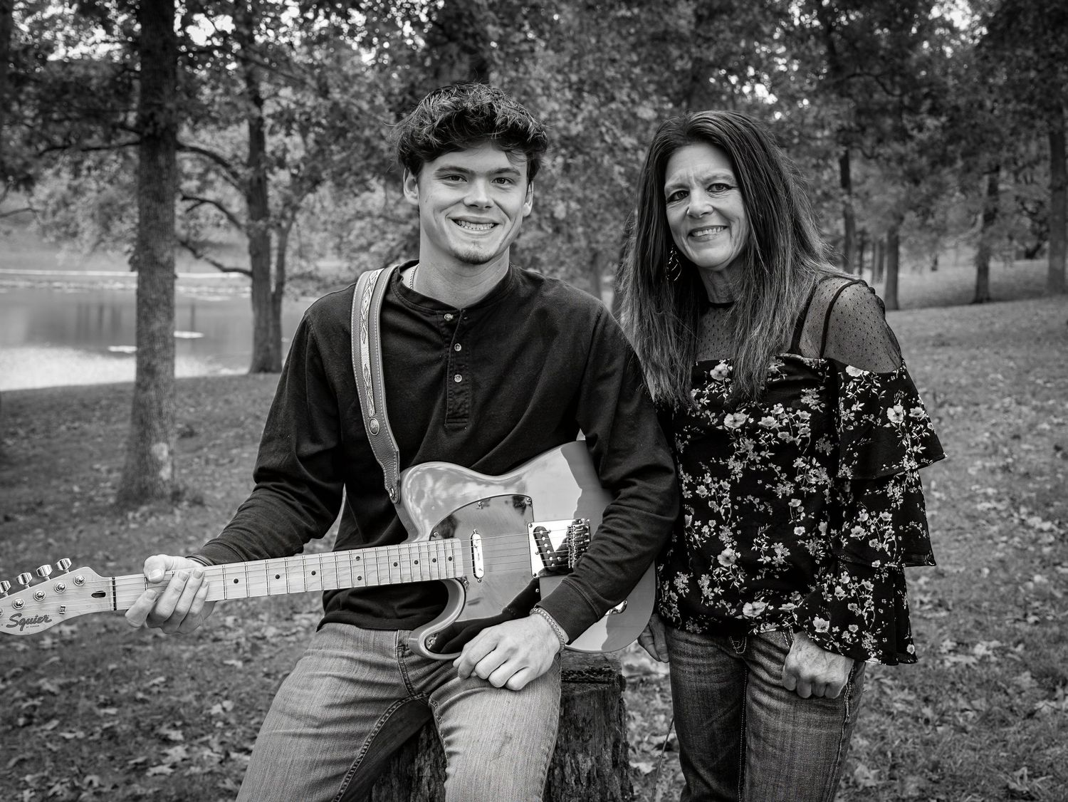 A black and white photo series showing a couple sitting together outdoors in a park setting during autumn.