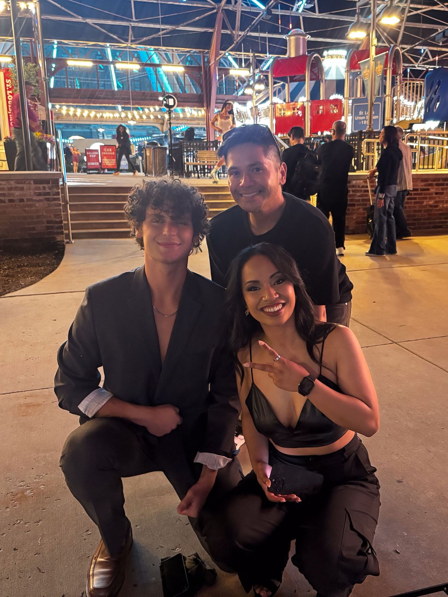 A group of friends enjoying a night out at an entertainment venue, dressed in black attire.