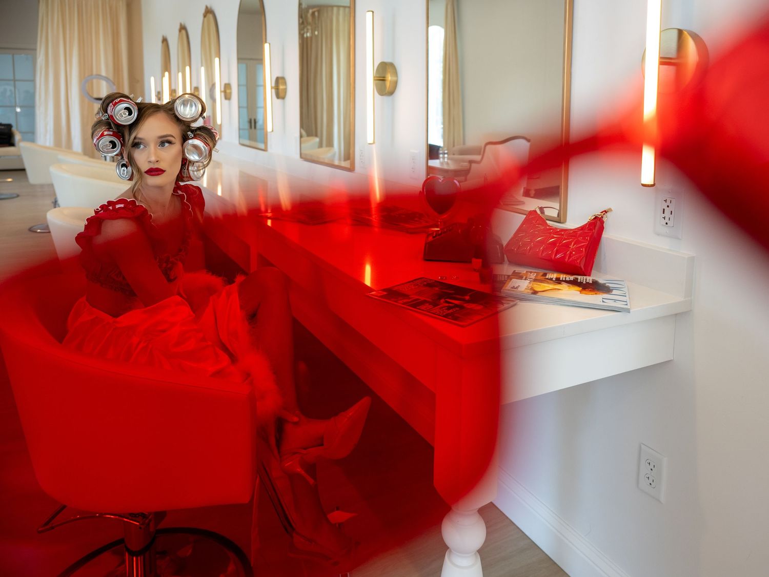Red smoke effects create a dramatic artistic atmosphere in a bright interior setting.