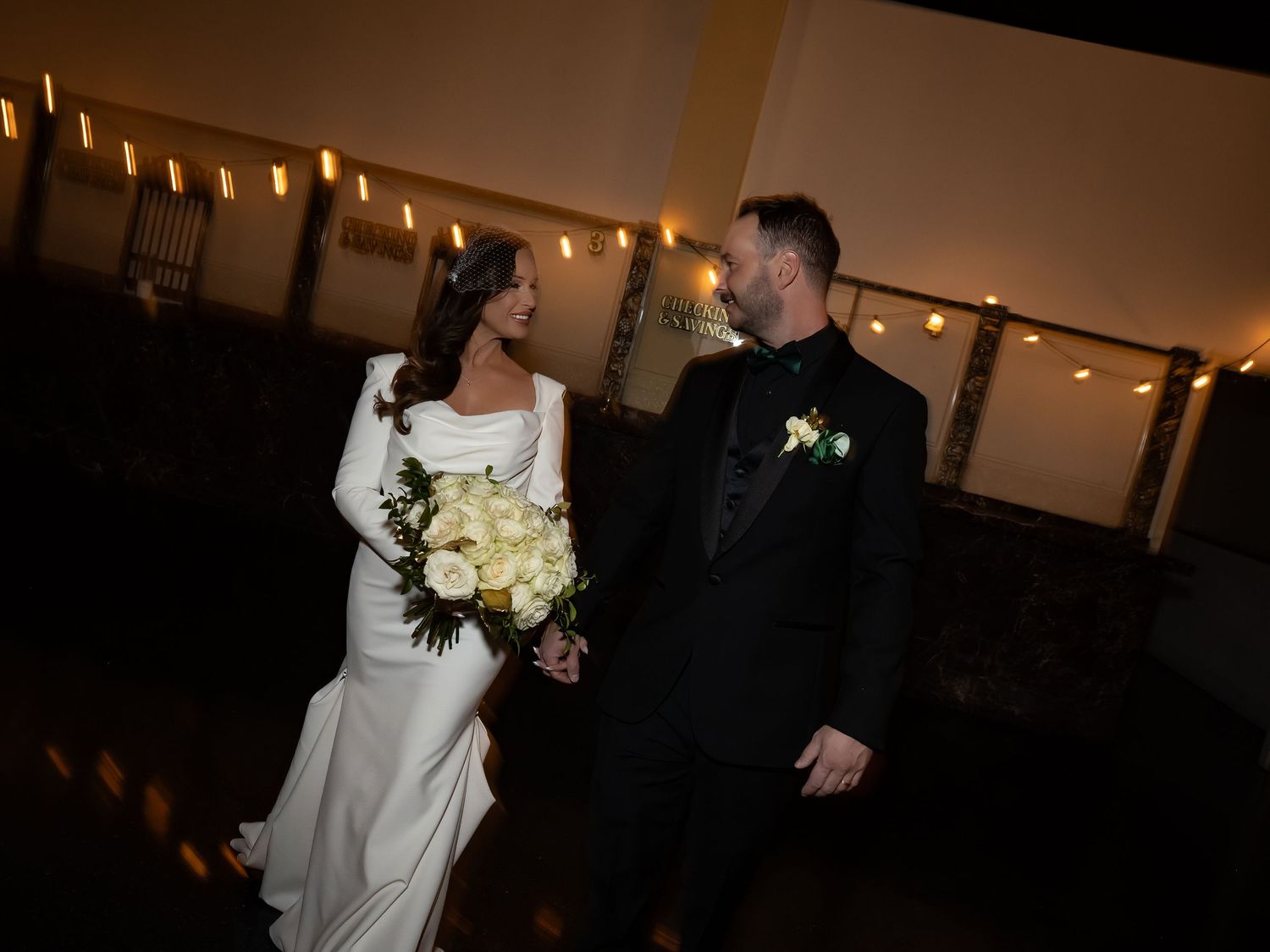 Wedding venue interior with string lights creating romantic ambient lighting.