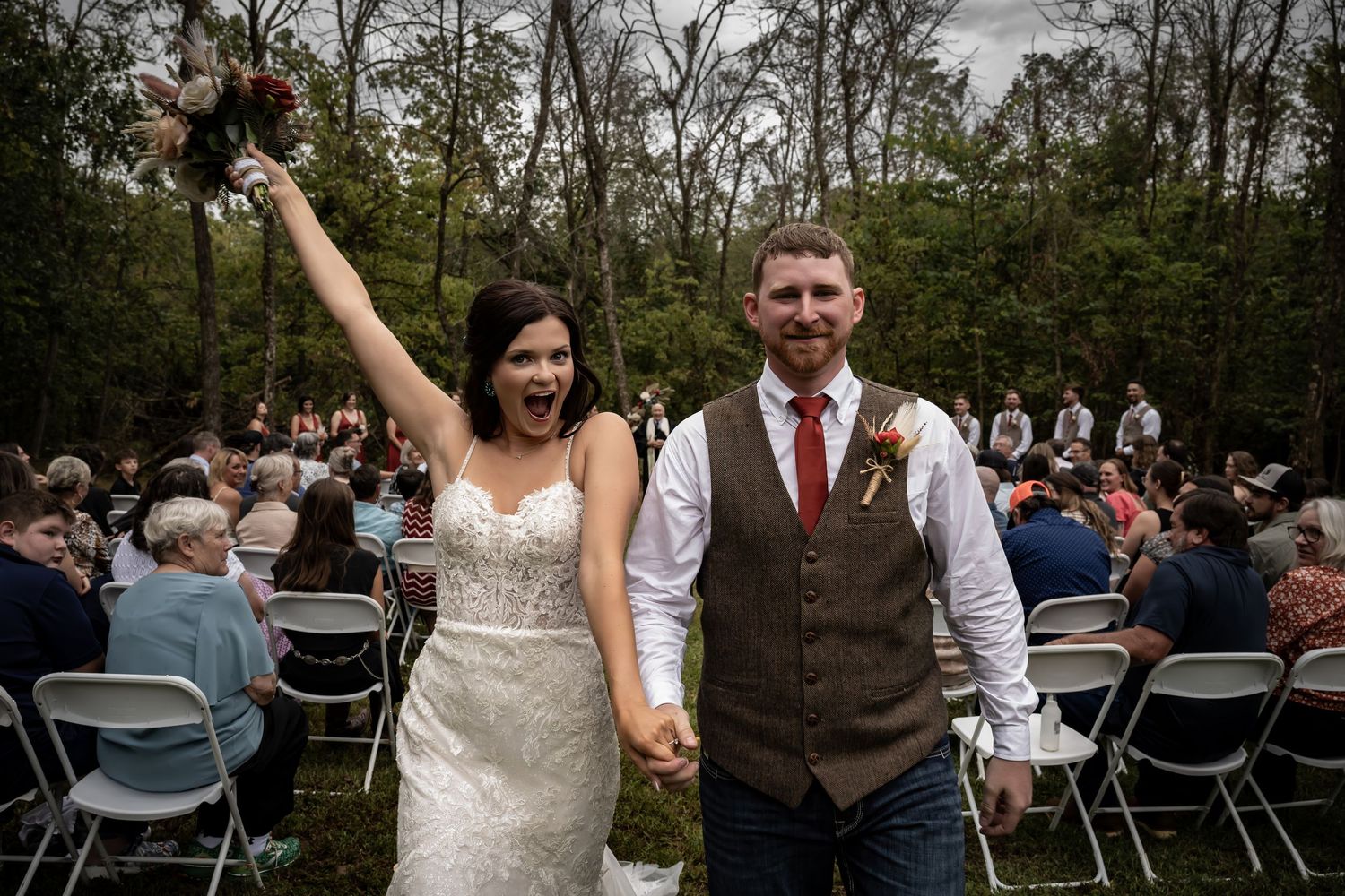 Wedding ceremony setup outdoors with folding chairs and natural scenery.