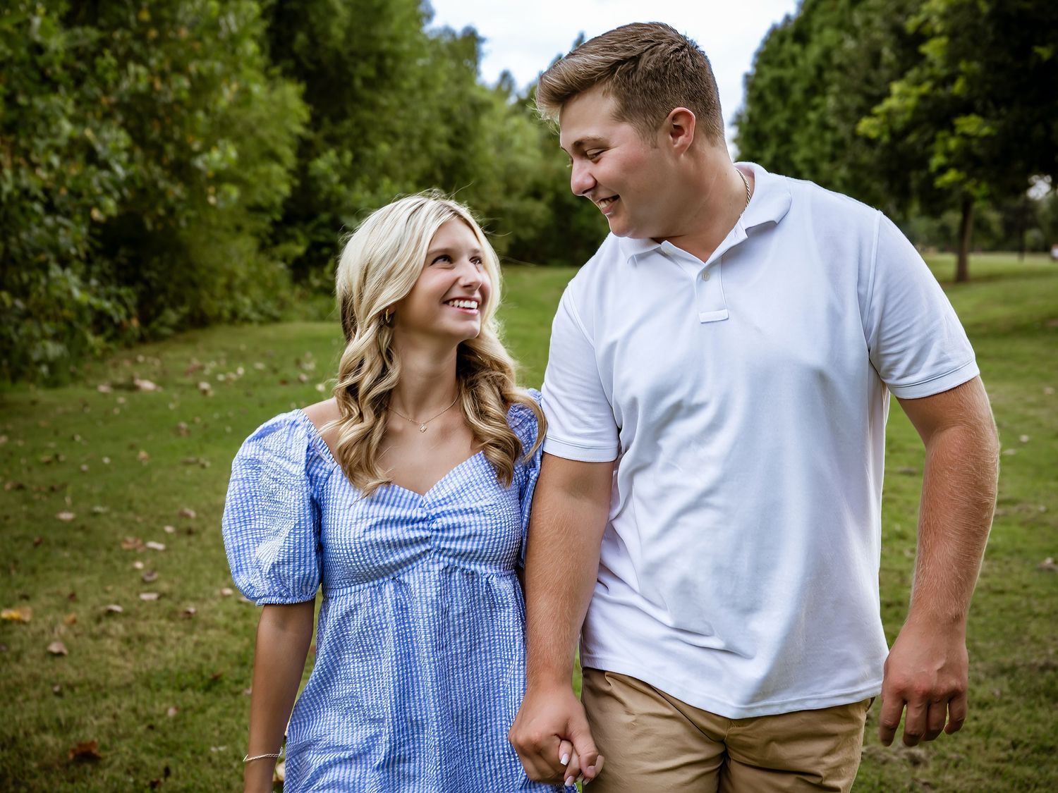 Couple in casual attire sharing a joyful moment together outdoors.