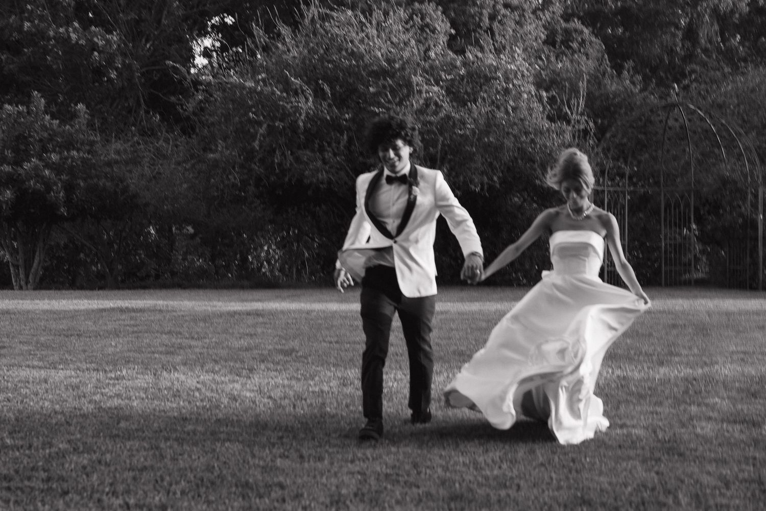 Black and white artistic wedding photography showing romantic moments in a natural setting.