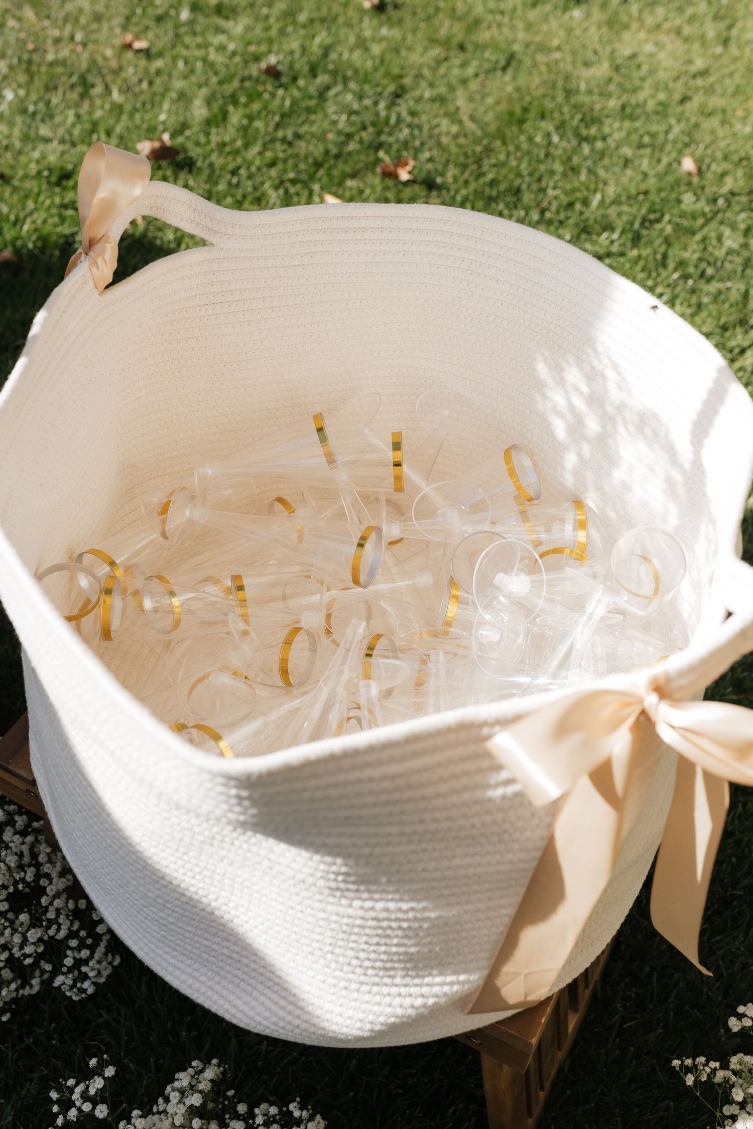 White woven basket filled with wedding bubbles tied with cream colored ribbon.