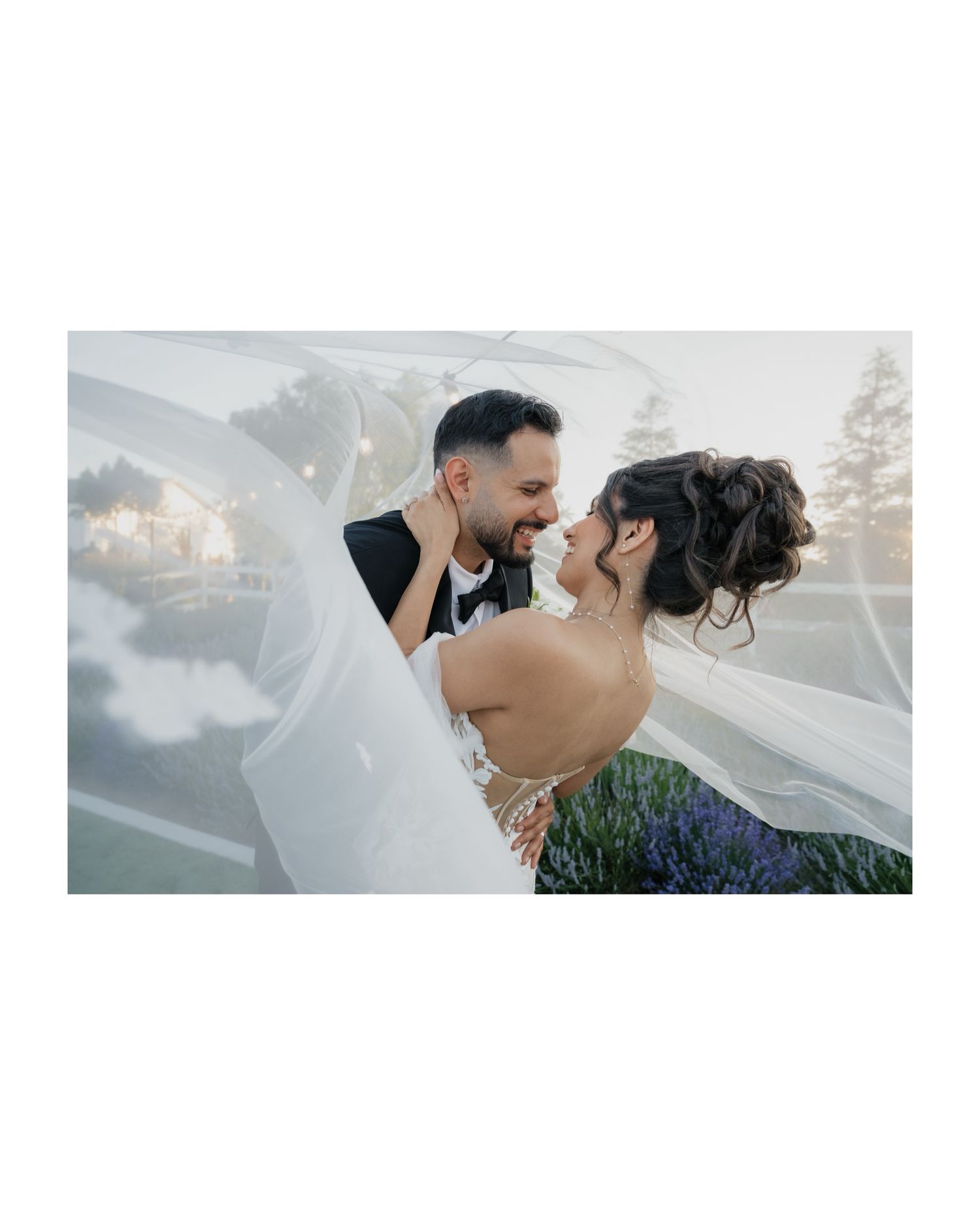 Romantic sunset wedding portrait against scenic mountain backdrop.