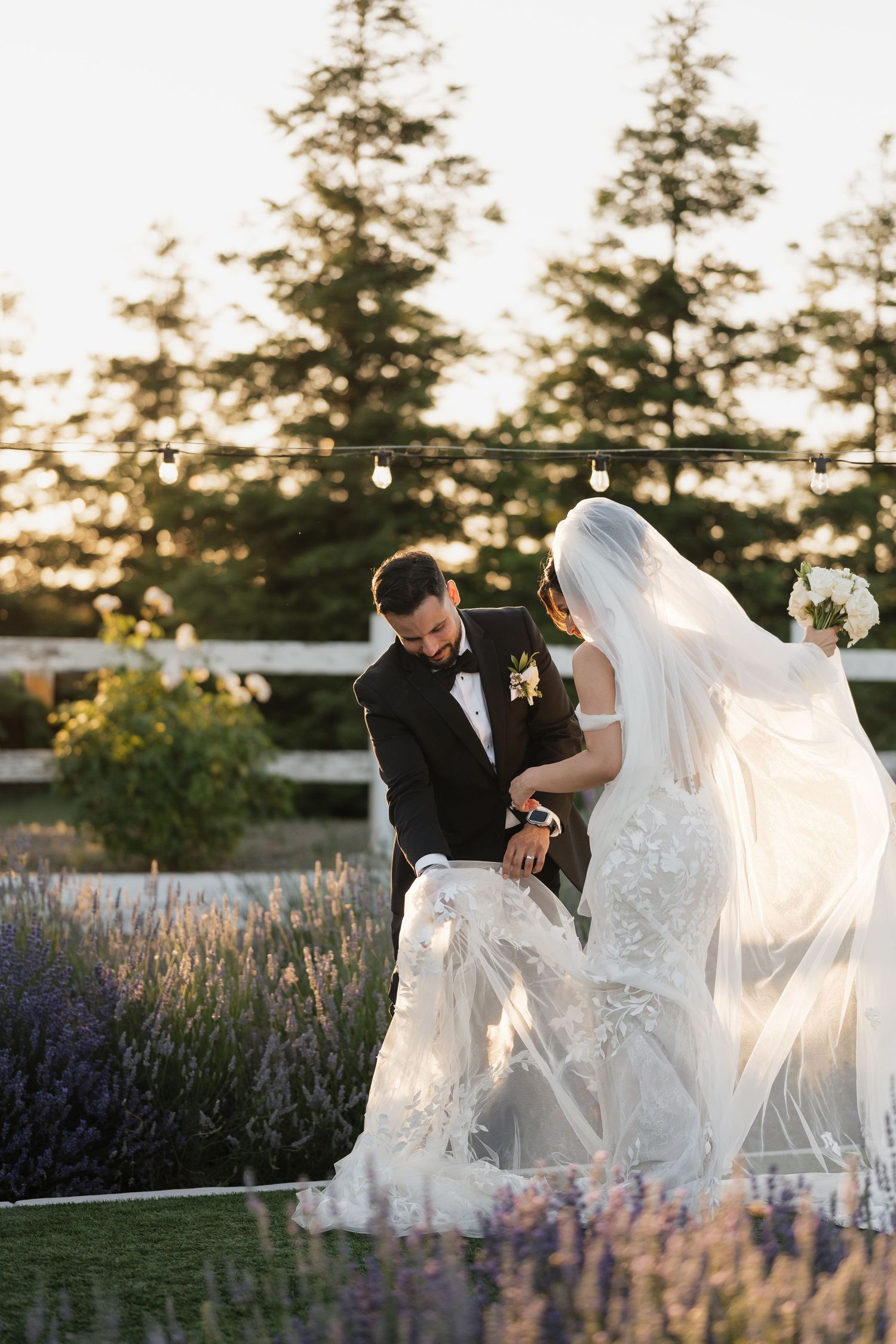 A romantic wedding photoshoot in a lavender field at sunset shows an elegant couple in formal attire.