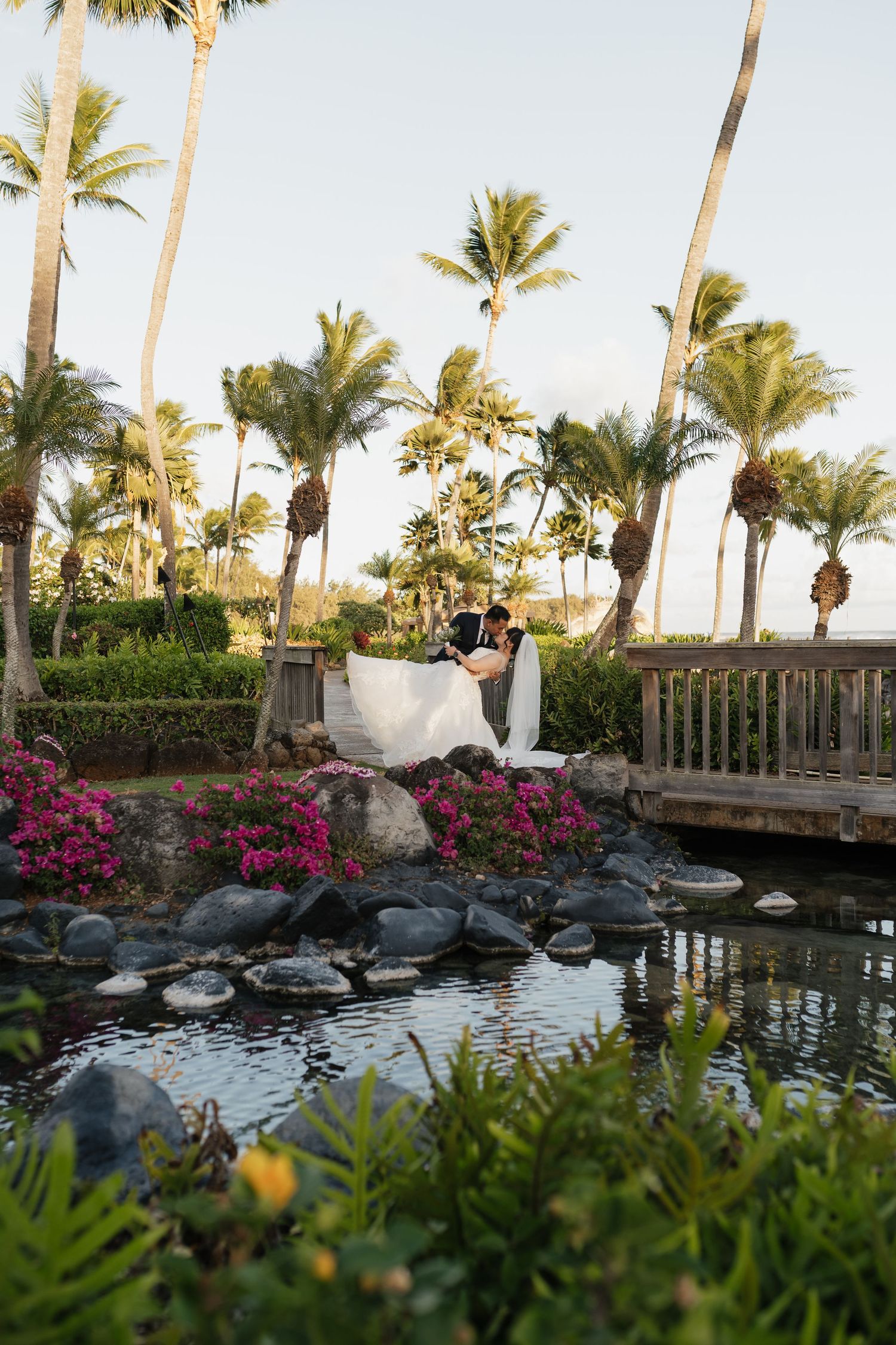 Tropical wedding venue with palm trees and a serene koi pond in Hawaii.
