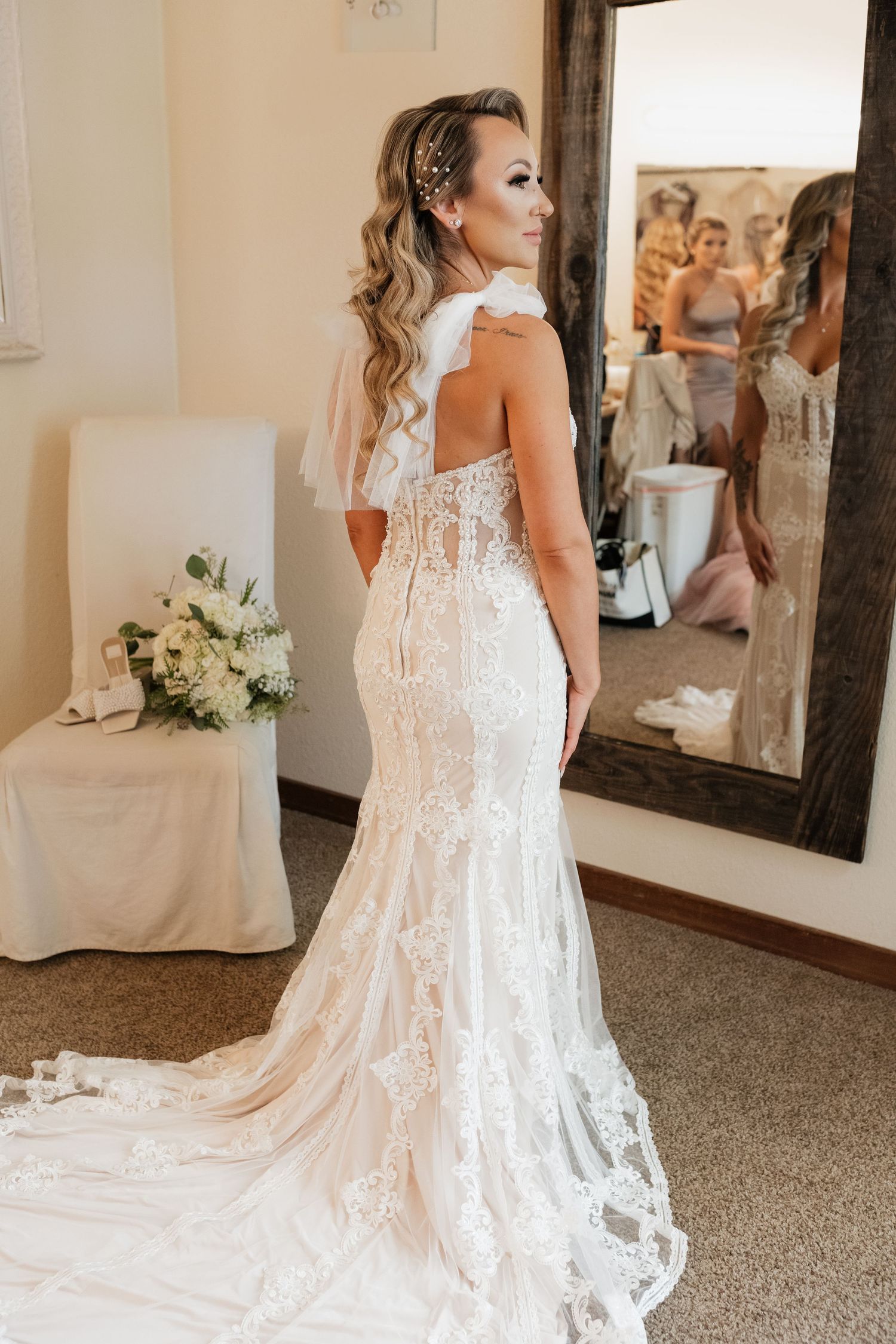 Detailed back view of an intricate lace wedding dress with flowing train.