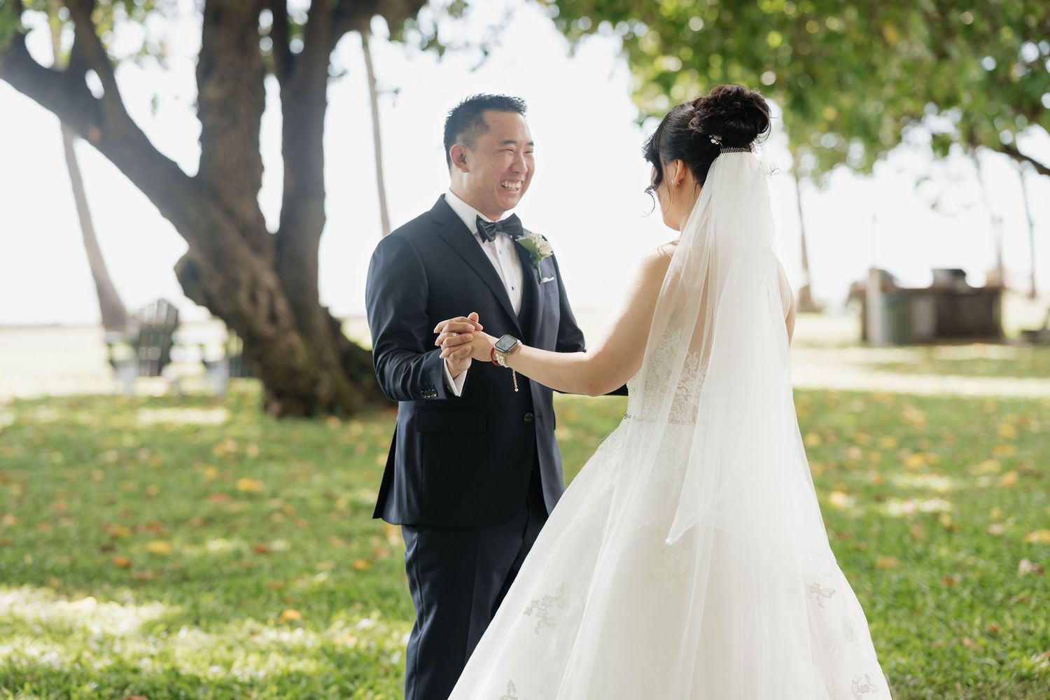 Wedding photos captured on green lawn with trees in background.
