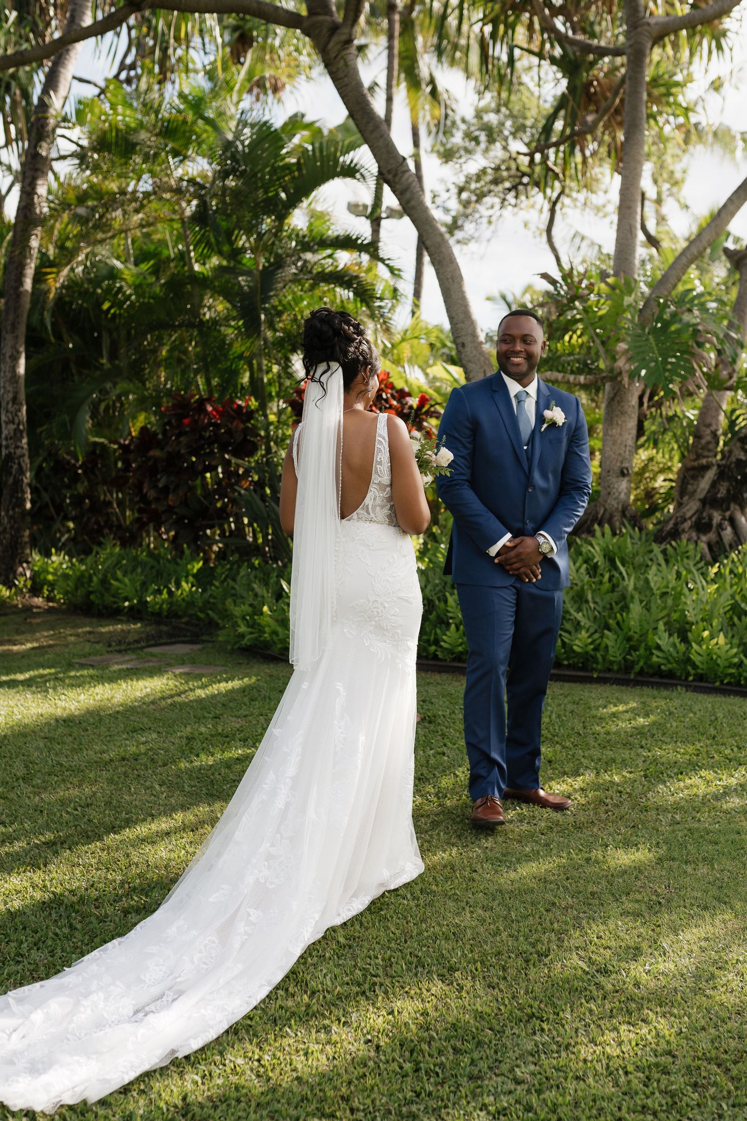 A wedding moment captured in a tropical garden setting with lush greenery.