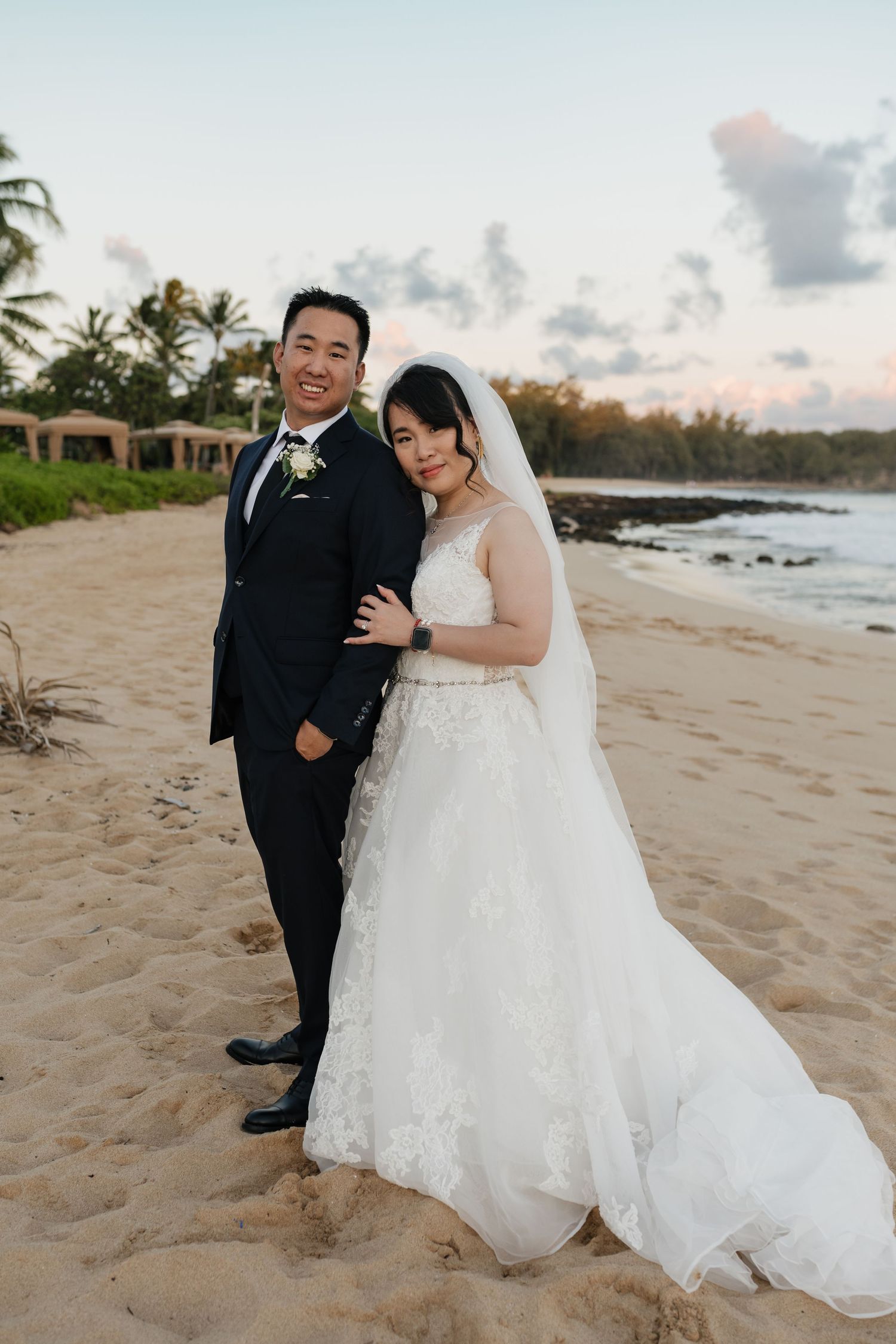 Romantic beach wedding photos with palm trees and ocean views at sunset.