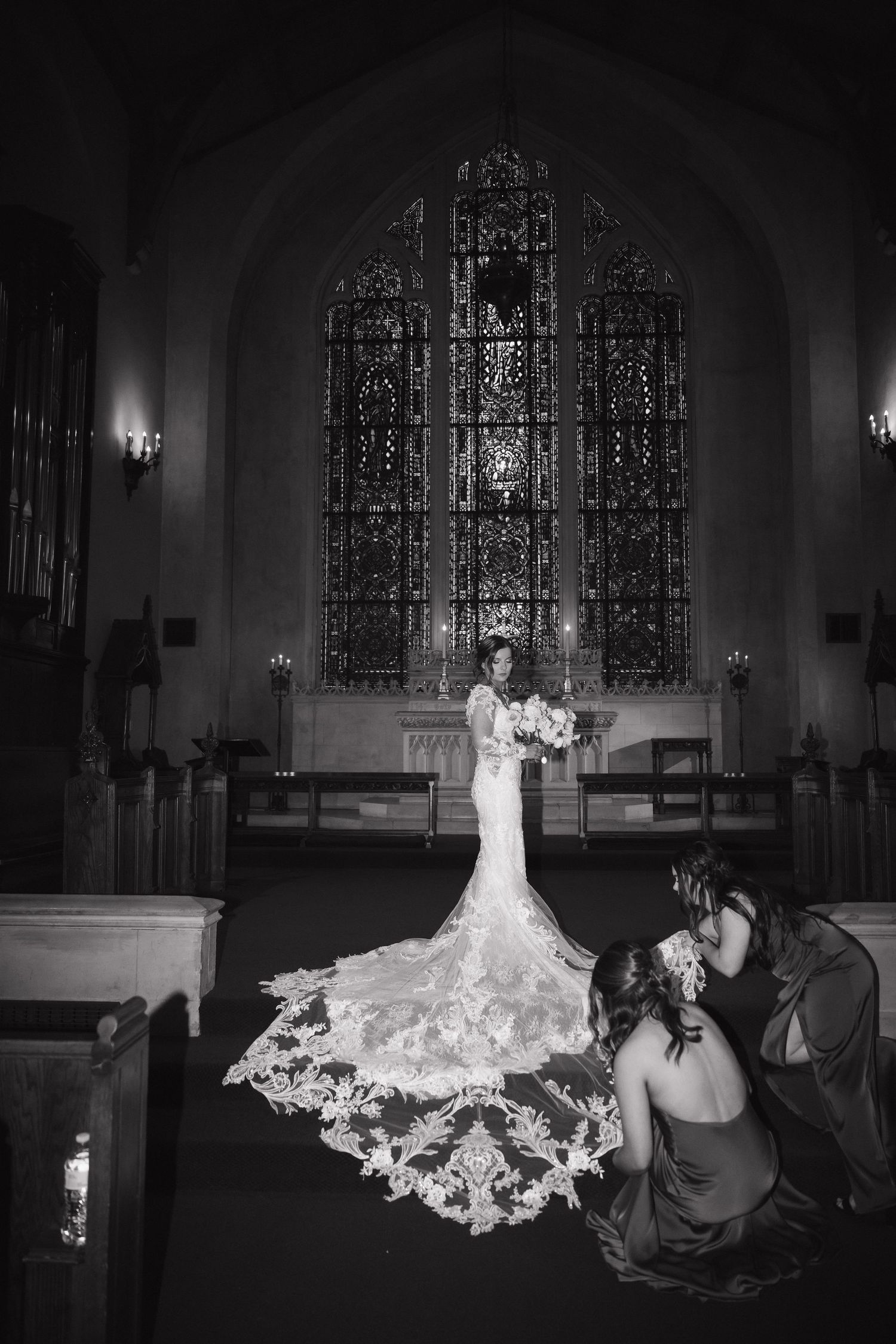 Dramatic black and white photos showcase a wedding dress in a traditional church setting.