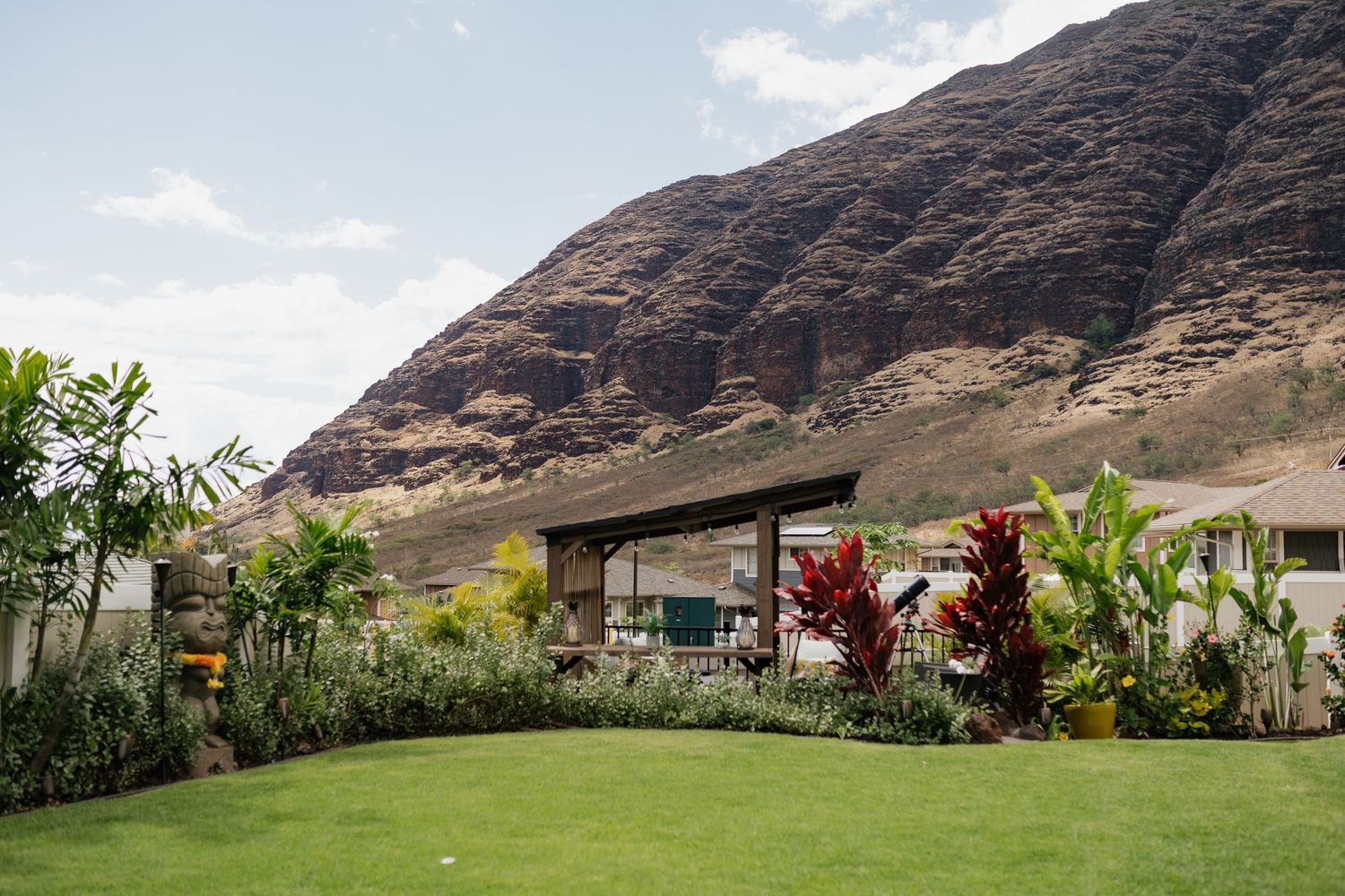 Mountain landscape with palm trees and tropical foliage creating a scenic outdoor wedding venue.