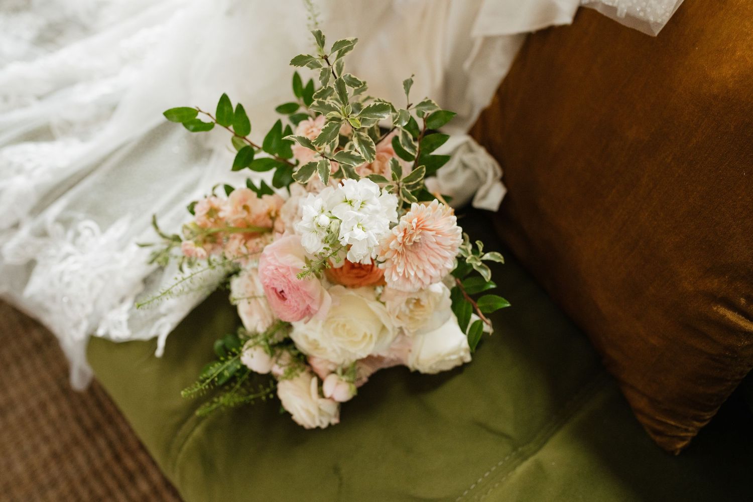 Soft pink and white floral arrangements with delicate greenery for a wedding.
