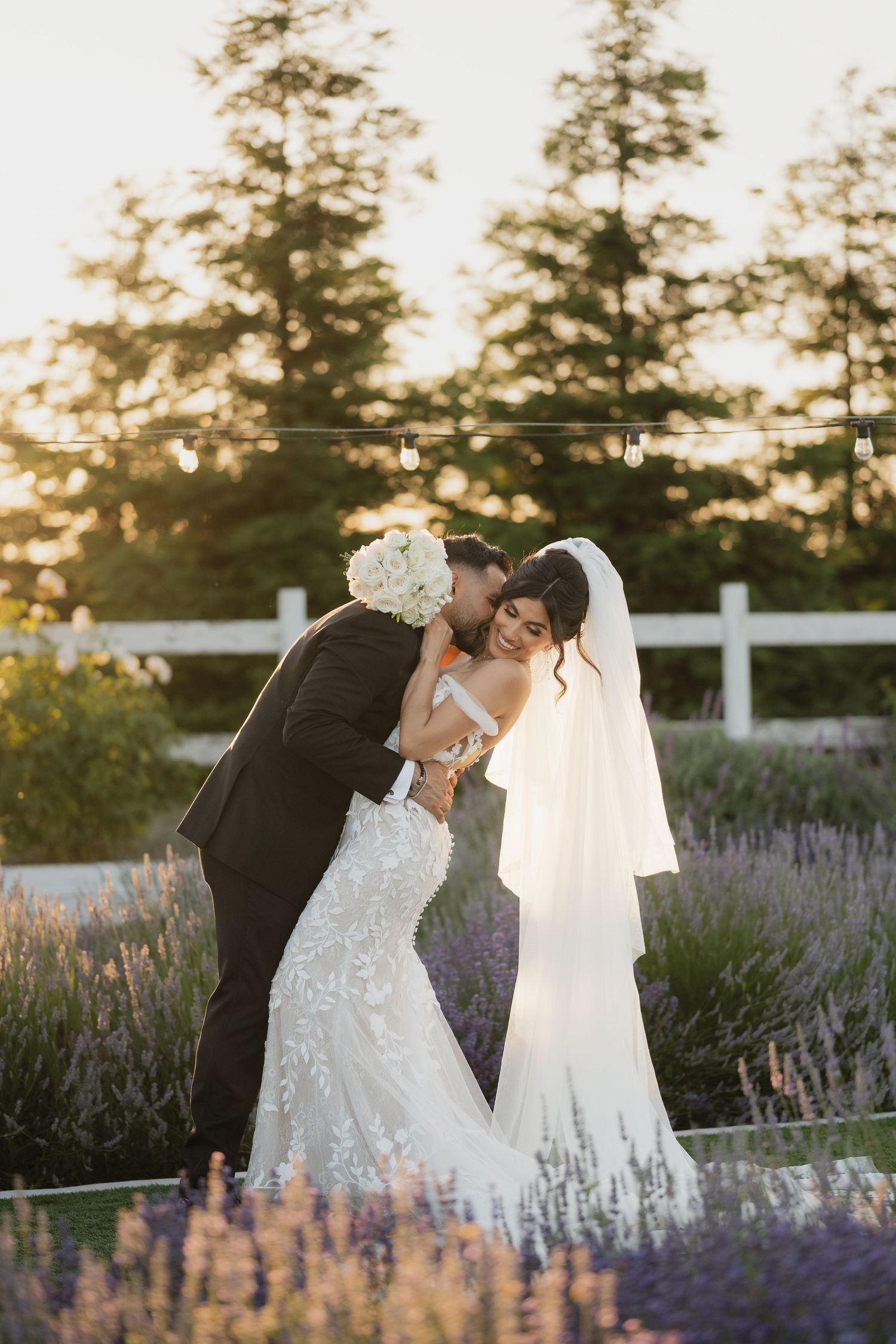 Romantic wedding portraits among blooming lavender fields at sunset.