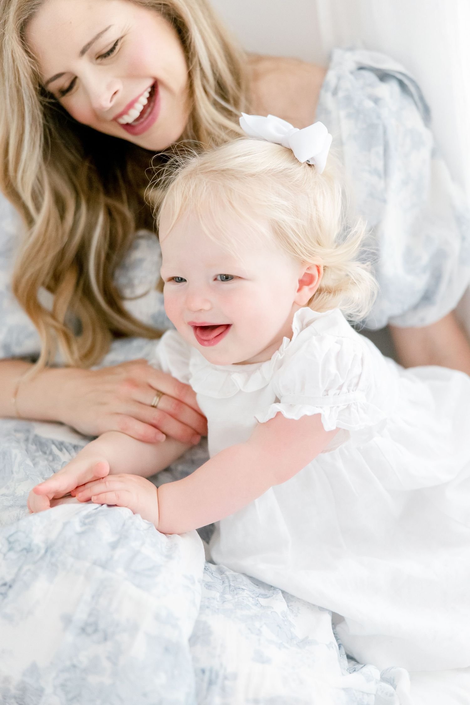 A joyful moment captured in white as they interact playfully together on a bright background.
