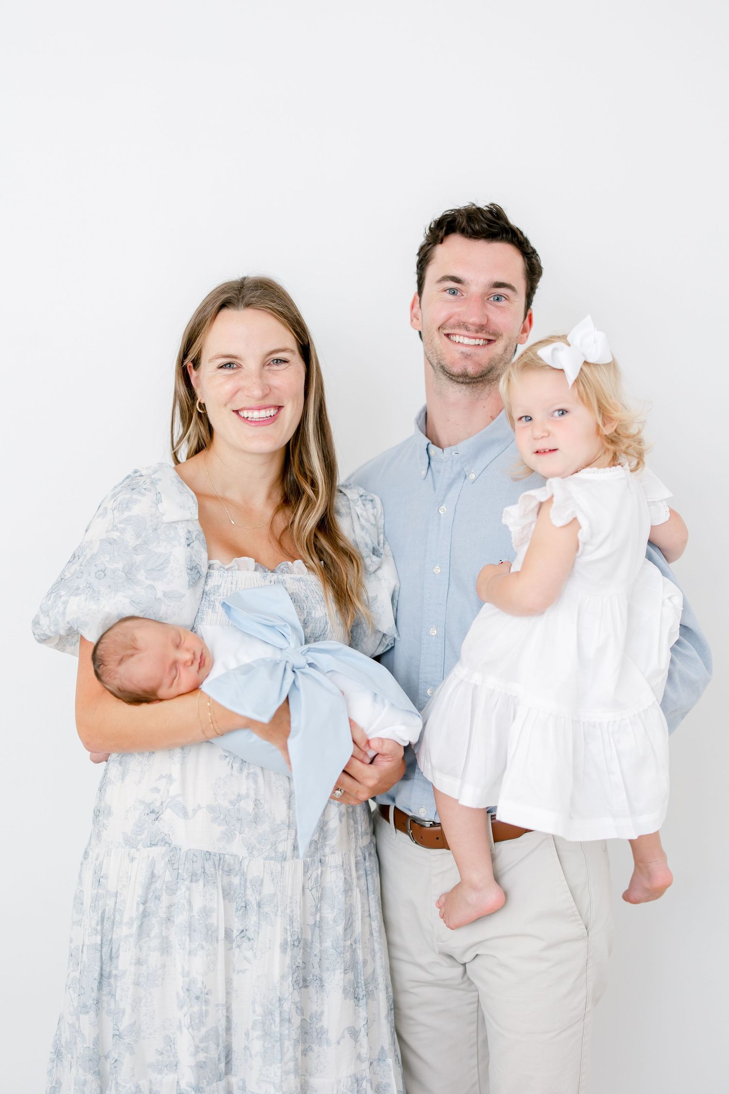 Family wearing coordinated light blue and white outfits poses together on a white background in a photo collage.